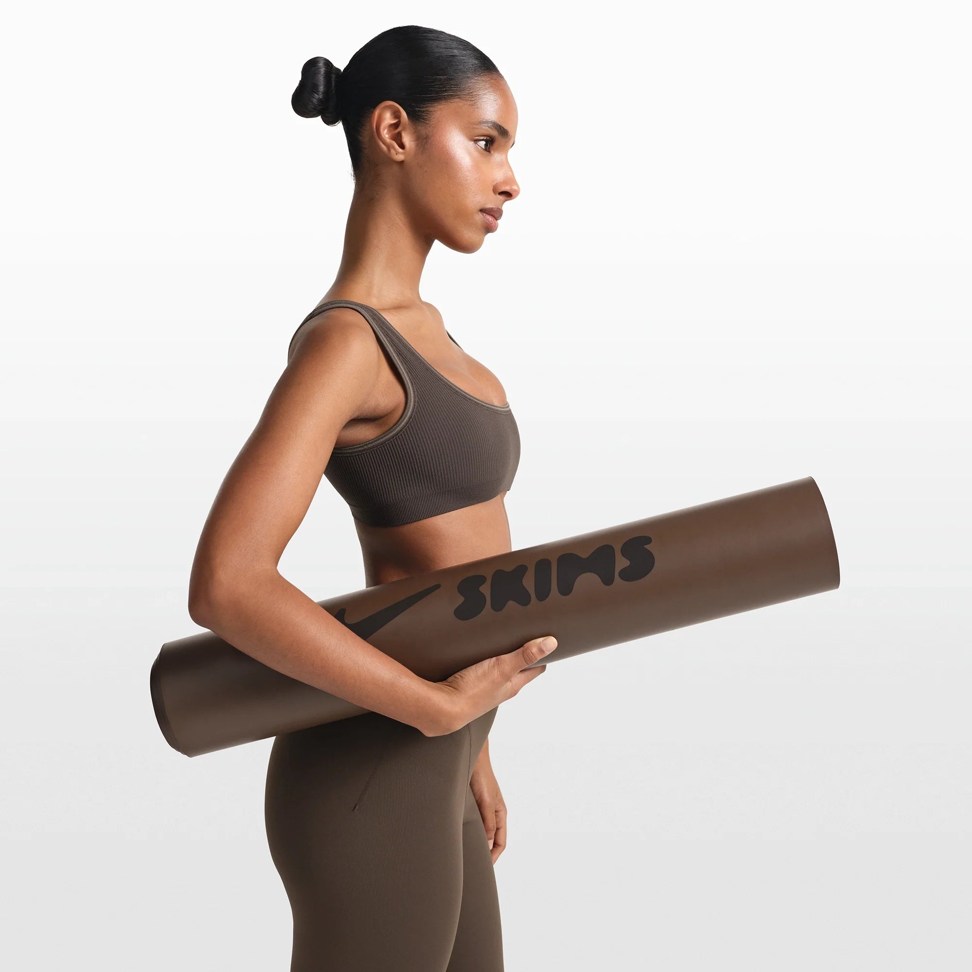 NikeSKIMS ACCESSORIES YOGA MAT | DARK SEPIA ON A MODEL FRONT VIEW @ | FOCUS: 0.0, 1.0, 0.9