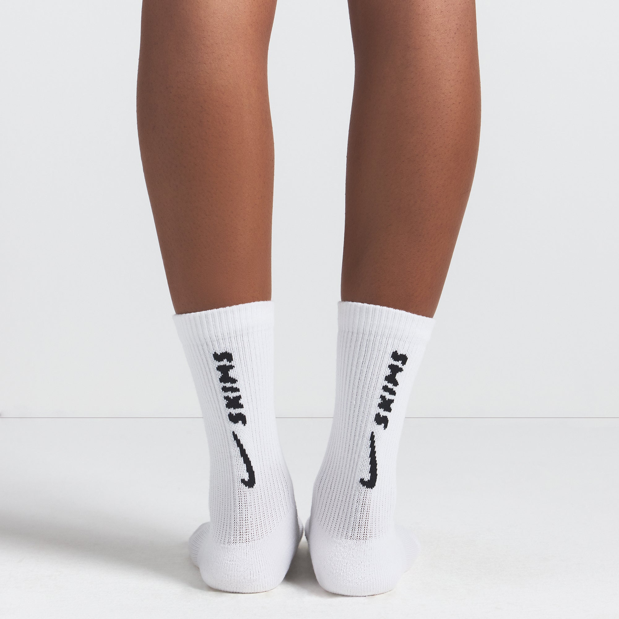 NikeSKIMS ACCESSORIES DRI-FIT™ CREW SOCK 3-PACK | HEATHER GREY MULTI & LAYS FLAT ON A WHITE BACKGROUND | FLT