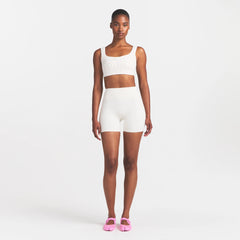 NikeSKIMS MATTE 5" BIKER SHORT | IVORY ON A MODEL 