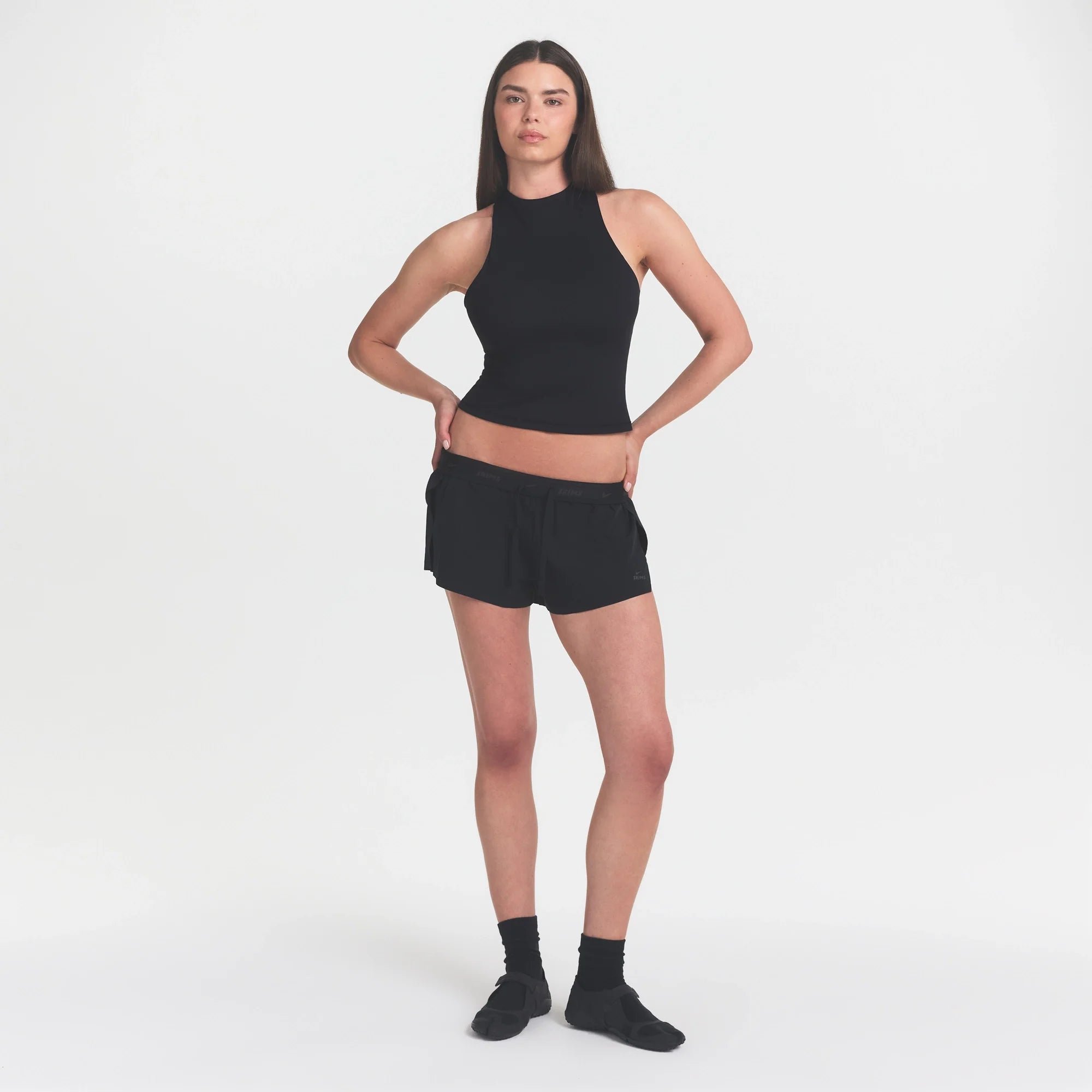 NikeSKIMS MATTE MOCK NECK RACER TANK | OBSIDIAN ON A MODEL FRONT VIEW @ | FOCUS: 0.0, 1.0, 0.9