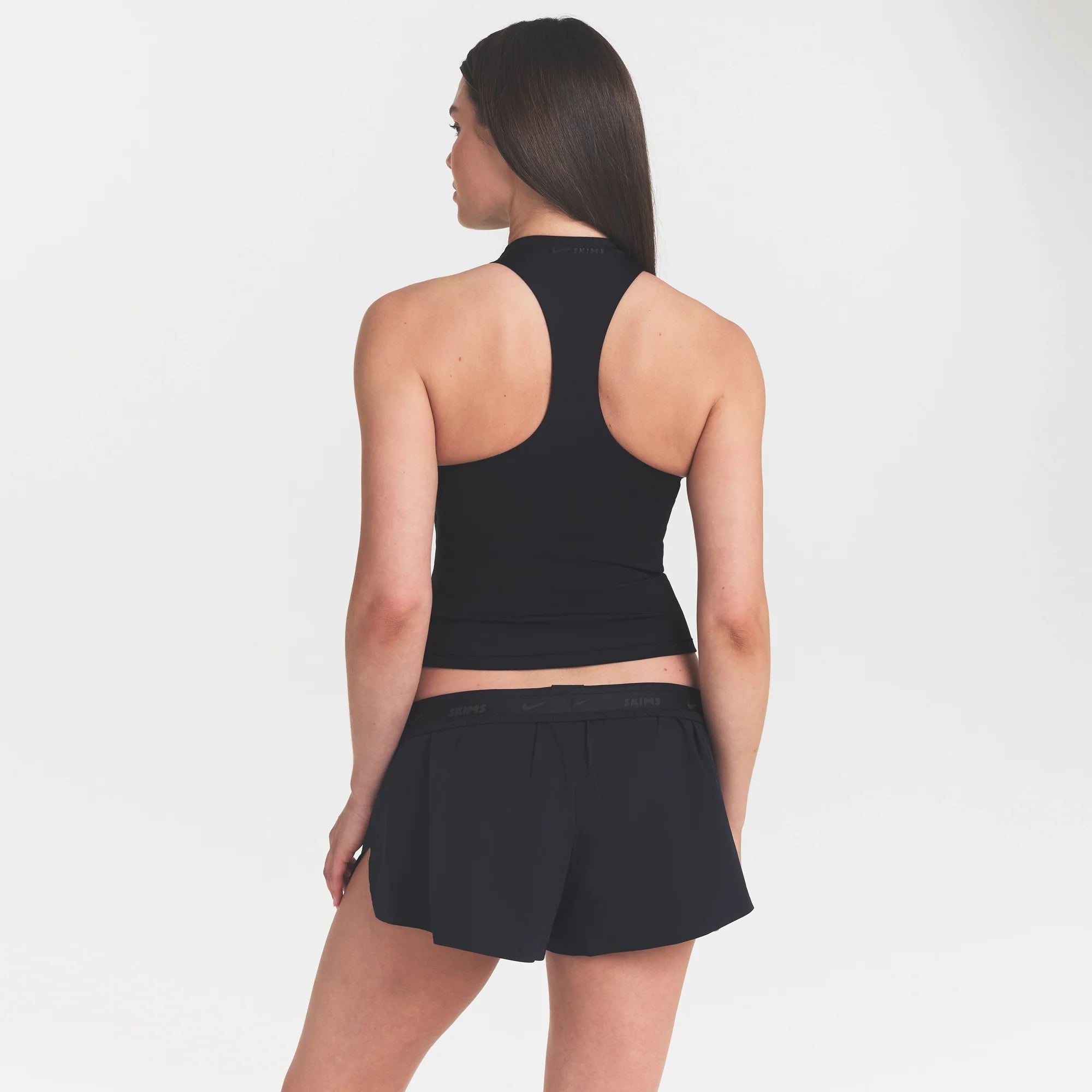 NikeSKIMS MATTE MOCK NECK RACER TANK | OBSIDIAN ON A MODEL FRONT VIEW @ | FOCUS: 0.9, 0.1, 0.7 @ | FOCUS: 0.0, 1.0, 0.9