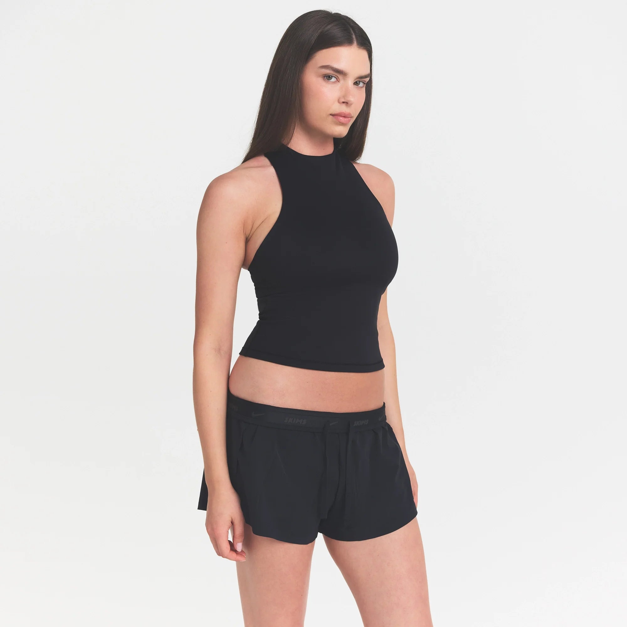 NikeSKIMS MATTE MOCK NECK RACER TANK | OBSIDIAN ON A MODEL FRONT VIEW @ | FOCUS: 0.9, 0.1, 0.7 @ | FOCUS: 0.0, 1.0, 0.9