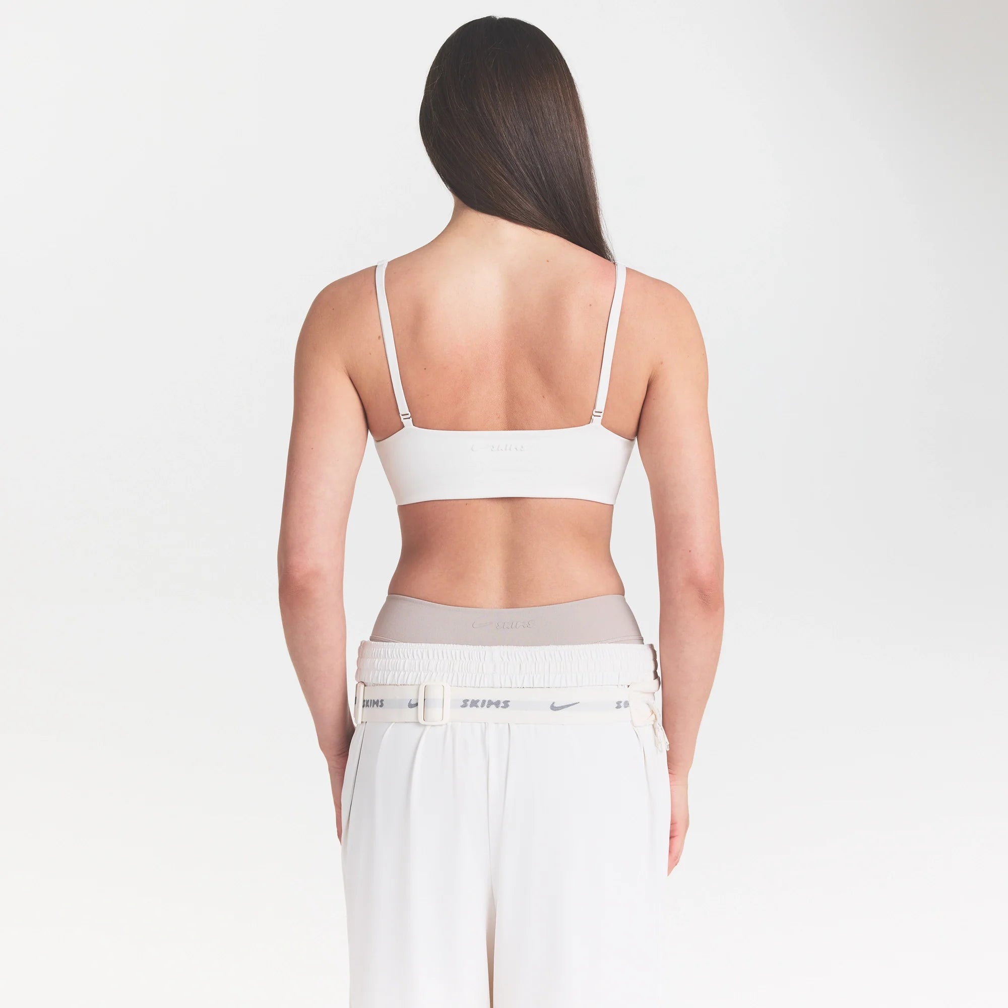NikeSKIMS MATTE MICRO SCOOP BRA | IVORY ON A MODEL 
