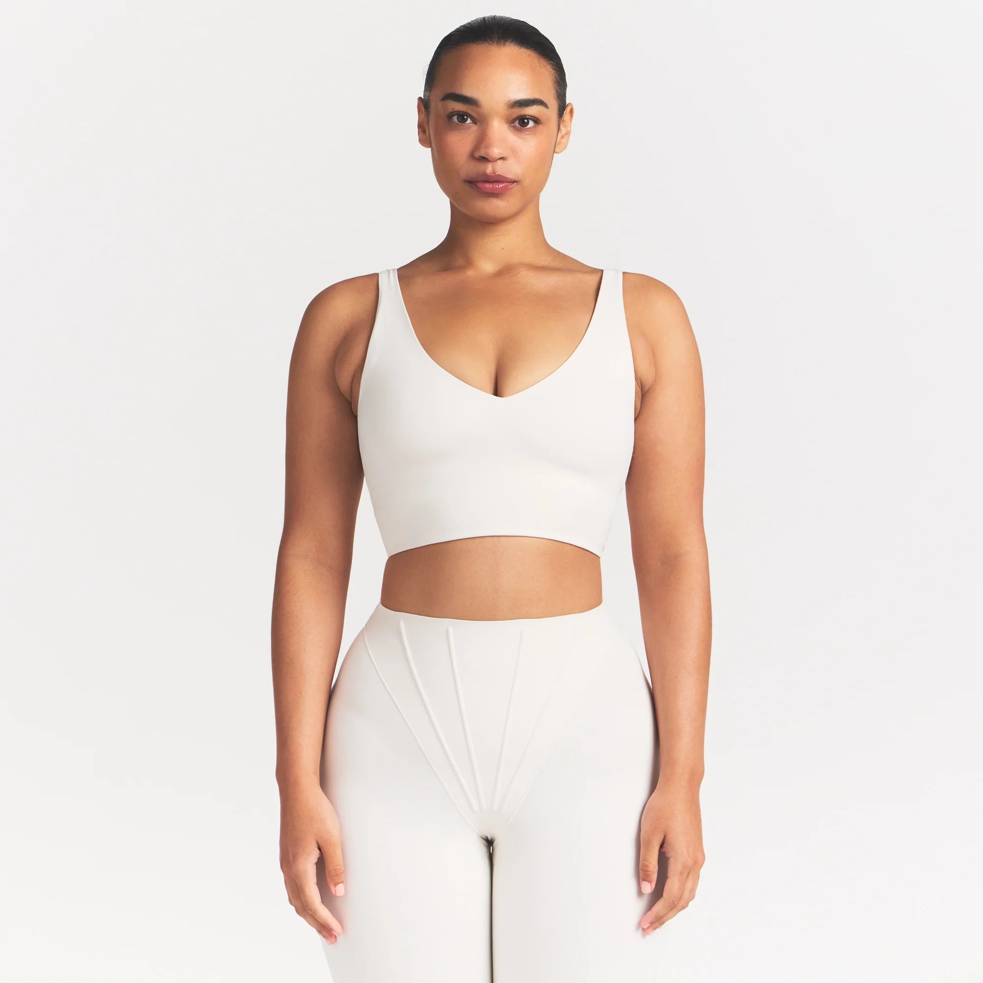NikeSKIMS MATTE V-NECK BRA TOP | IVORY ON A MODEL 