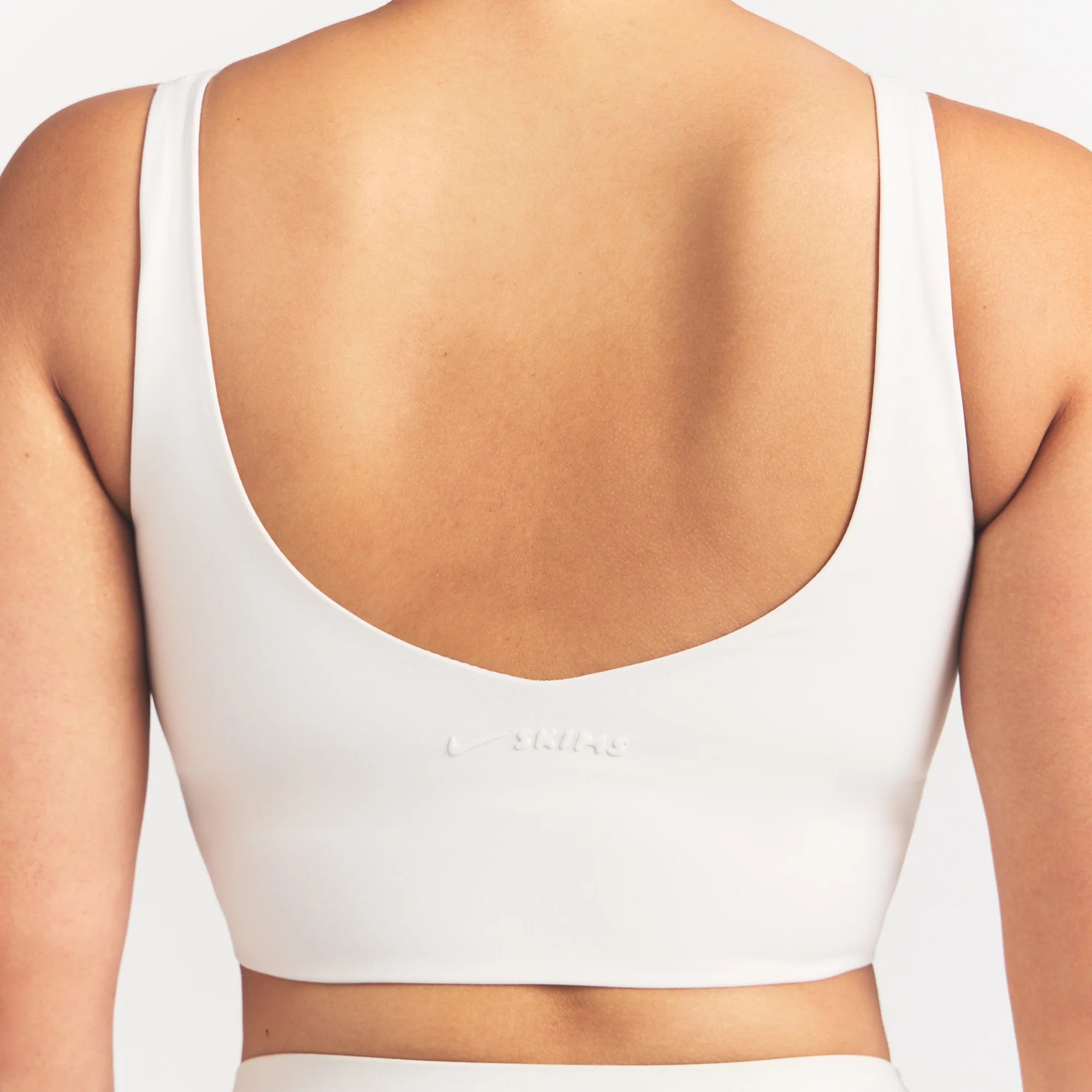 NikeSKIMS MATTE V-NECK BRA TOP | IVORY ON A MODEL 