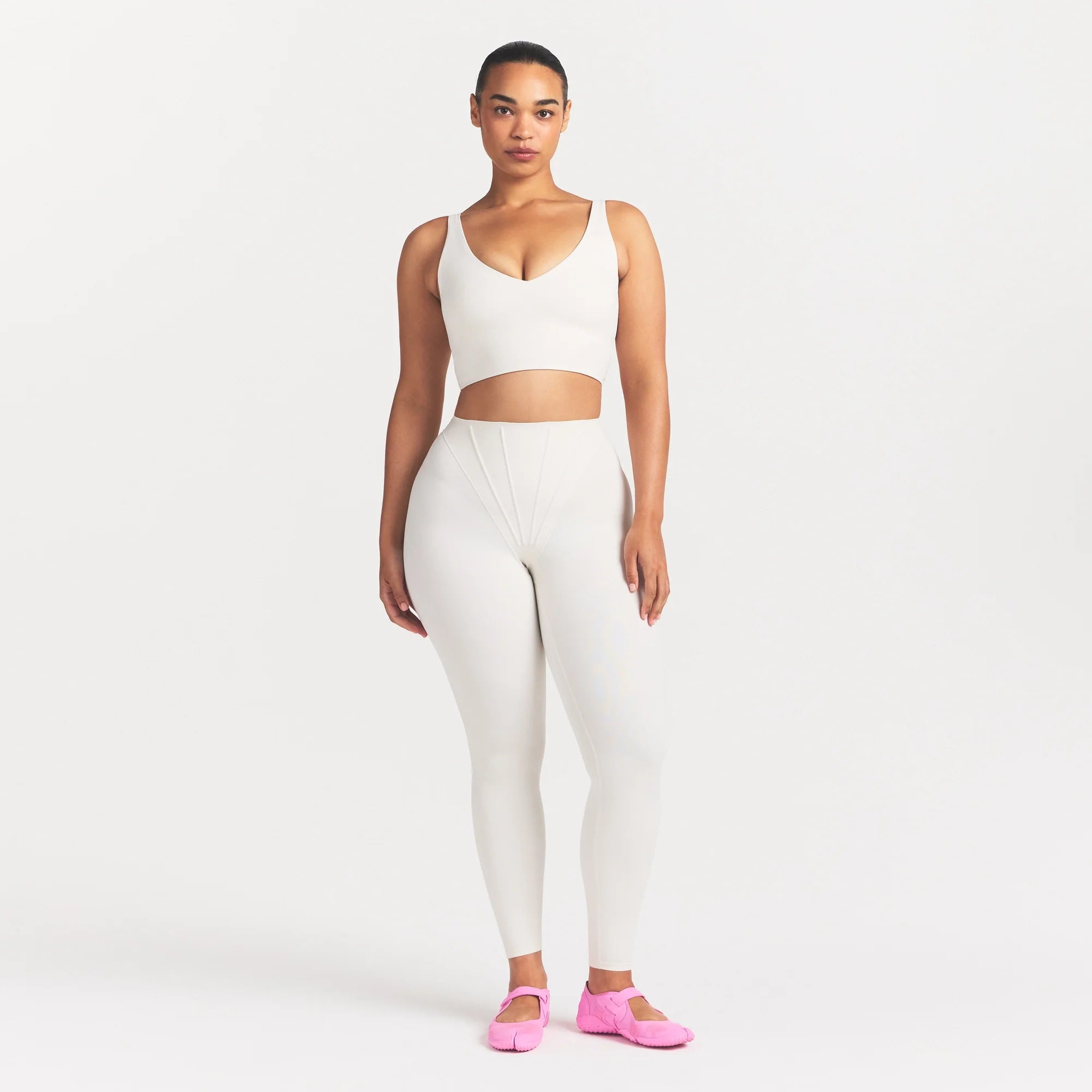 NikeSKIMS MATTE V-NECK BRA TOP | IVORY ON A MODEL 