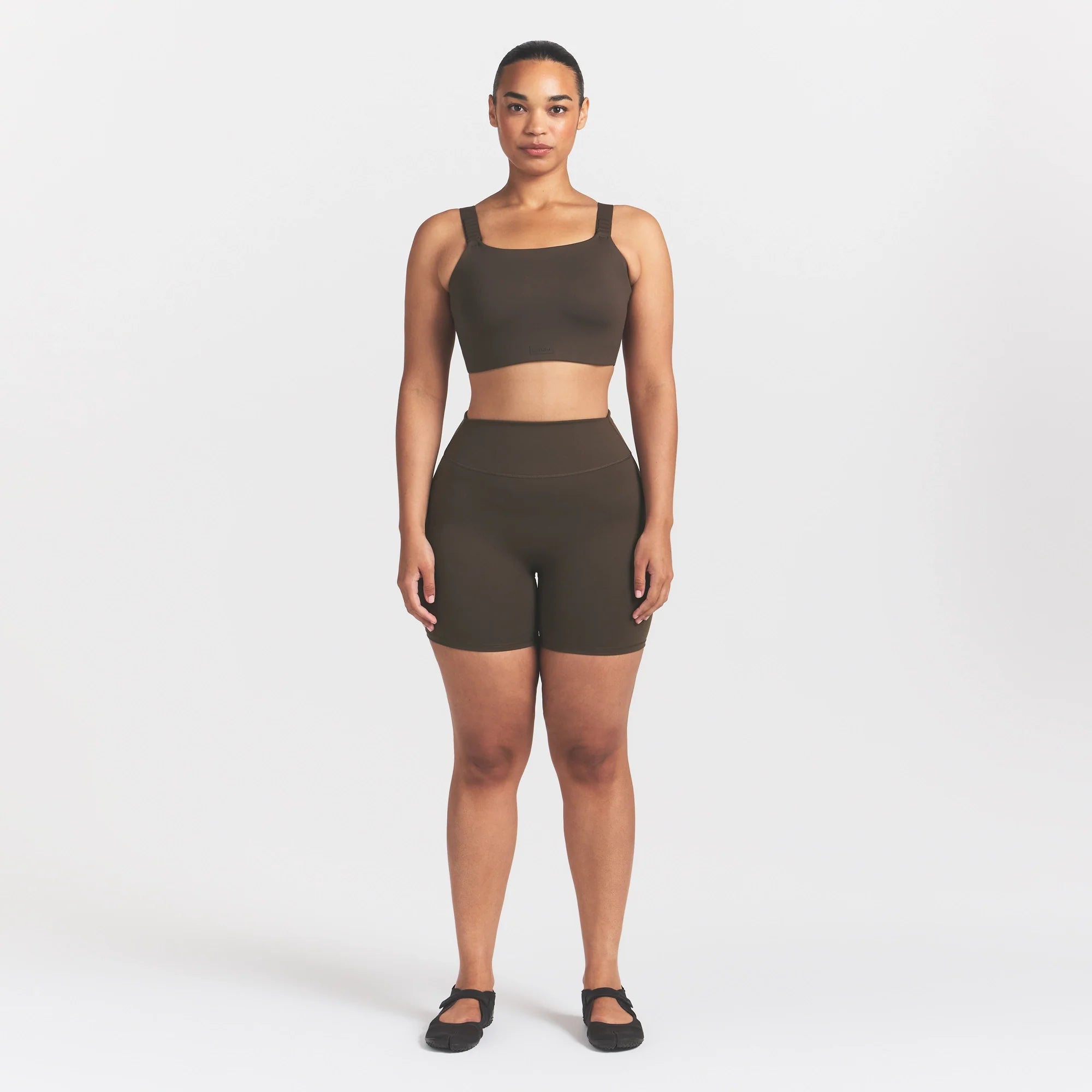 NikeSKIMS MATTE WIDE STRAP BRA | DARK SEPIA ON A MODEL FRONT VIEW @ | FOCUS: 0.9, 0.1, 0.7
