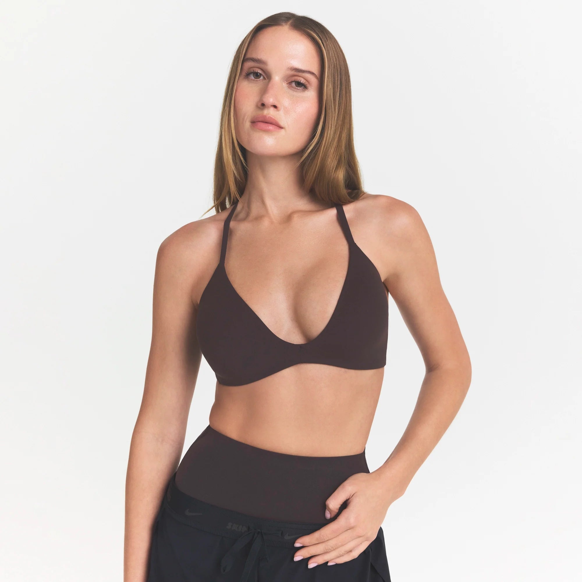 NikeSKIMS STUDIO STRETCH T-BACK TRIANGLE BRA | DARK ROASTON A MODEL FRONT @ | FOCUS: 0.0, 1.0, 0.9