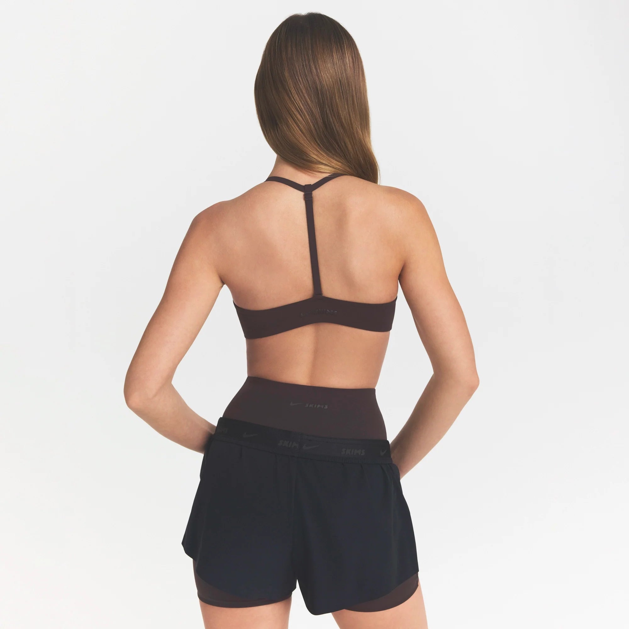 NikeSKIMS STUDIO STRETCH T-BACK TRIANGLE BRA | DARK ROASTON A MODEL FRONT 