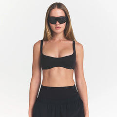 NikeSKIMS STUDIO STRETCH  SEAM FRONT MICRO BRA | OBSIDIANON A MODEL FRONT 