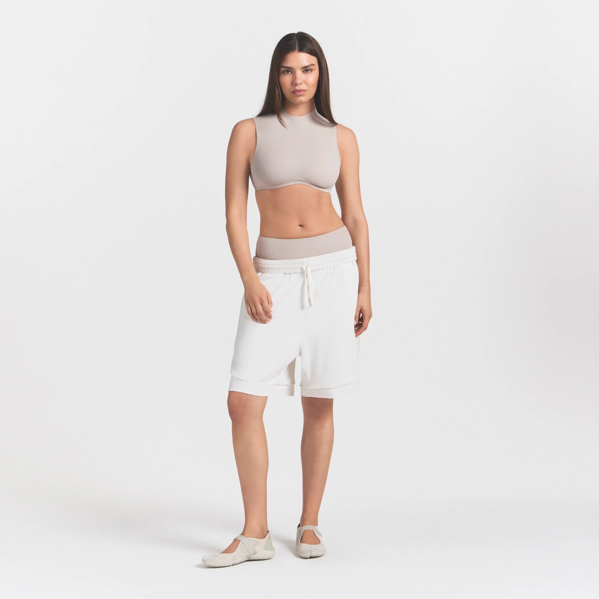 NikeSKIMS AIRY RELAXED SHORT | IVORY ON A MODEL 