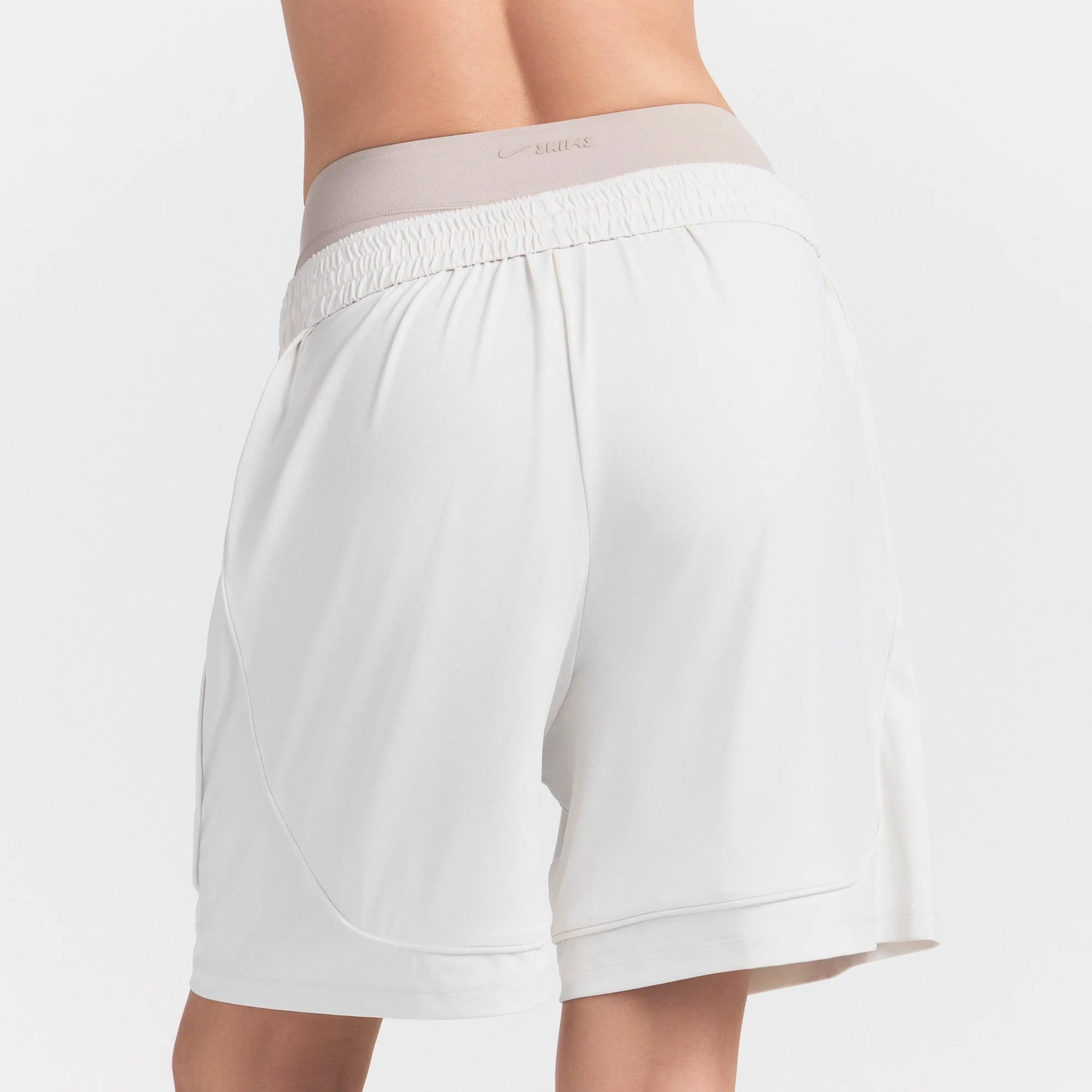 NikeSKIMS AIRY RELAXED SHORT | IVORY ON A MODEL 