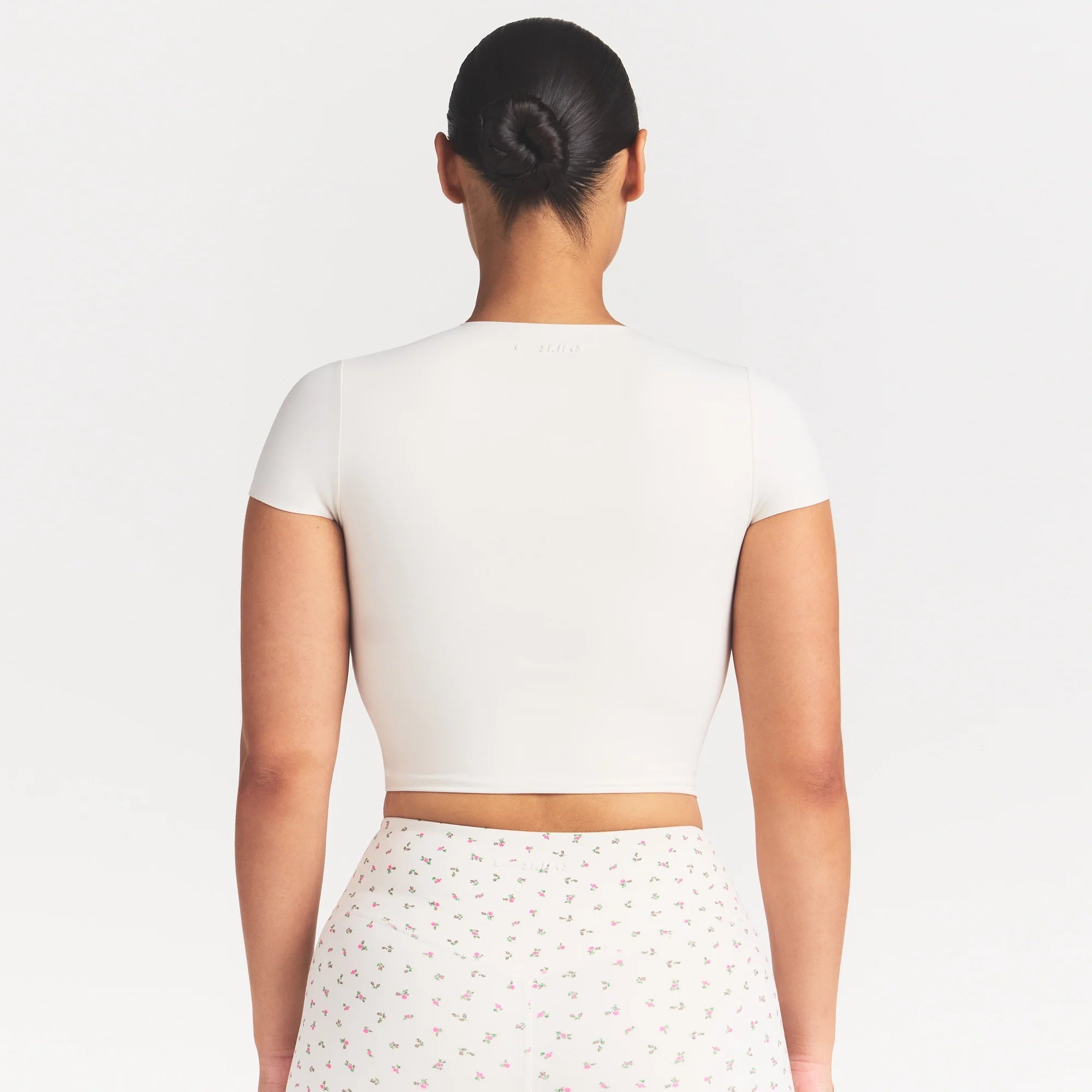 NikeSKIMS MATTE CORSET CROP TOP | IVORY ON A MODEL 
