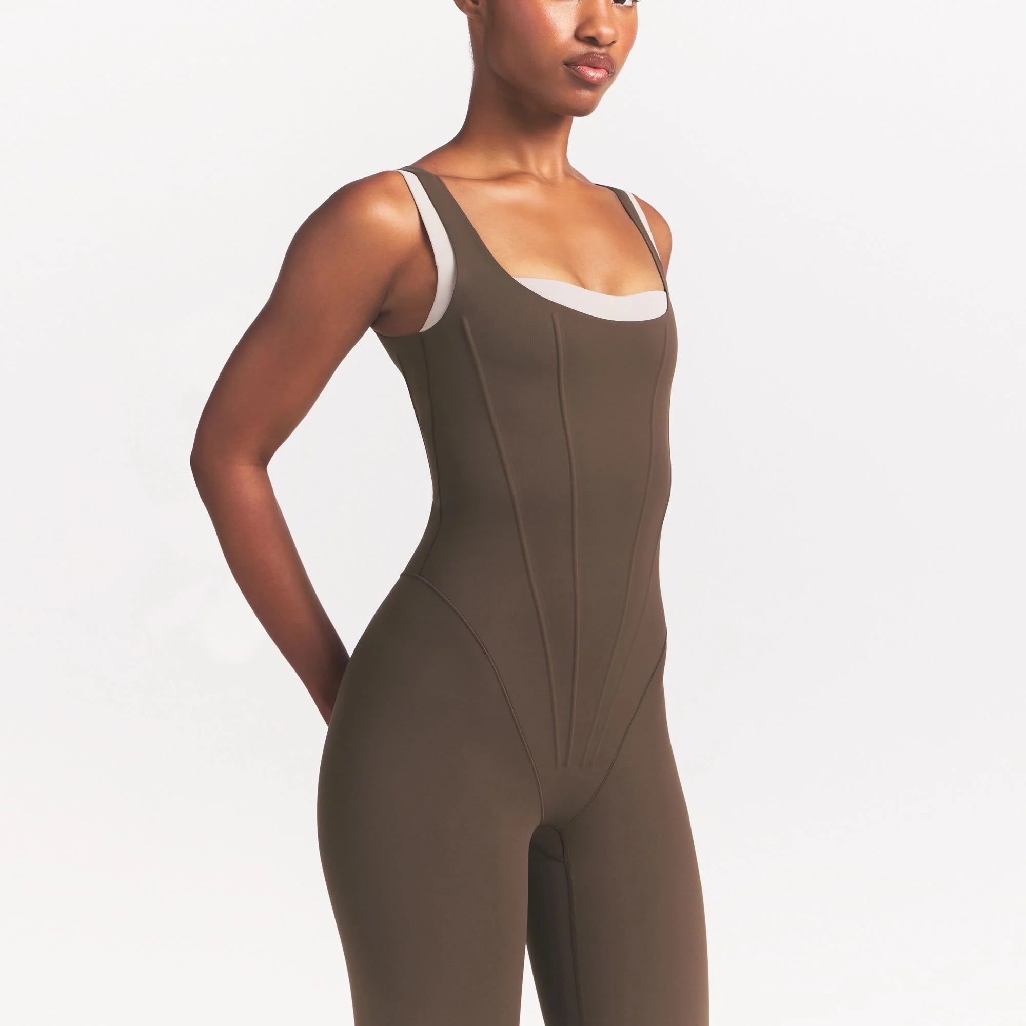 NikeSKIMS MATTE CORSET 29" ONE PIECE | DARK SEPIA ON A MODEL 