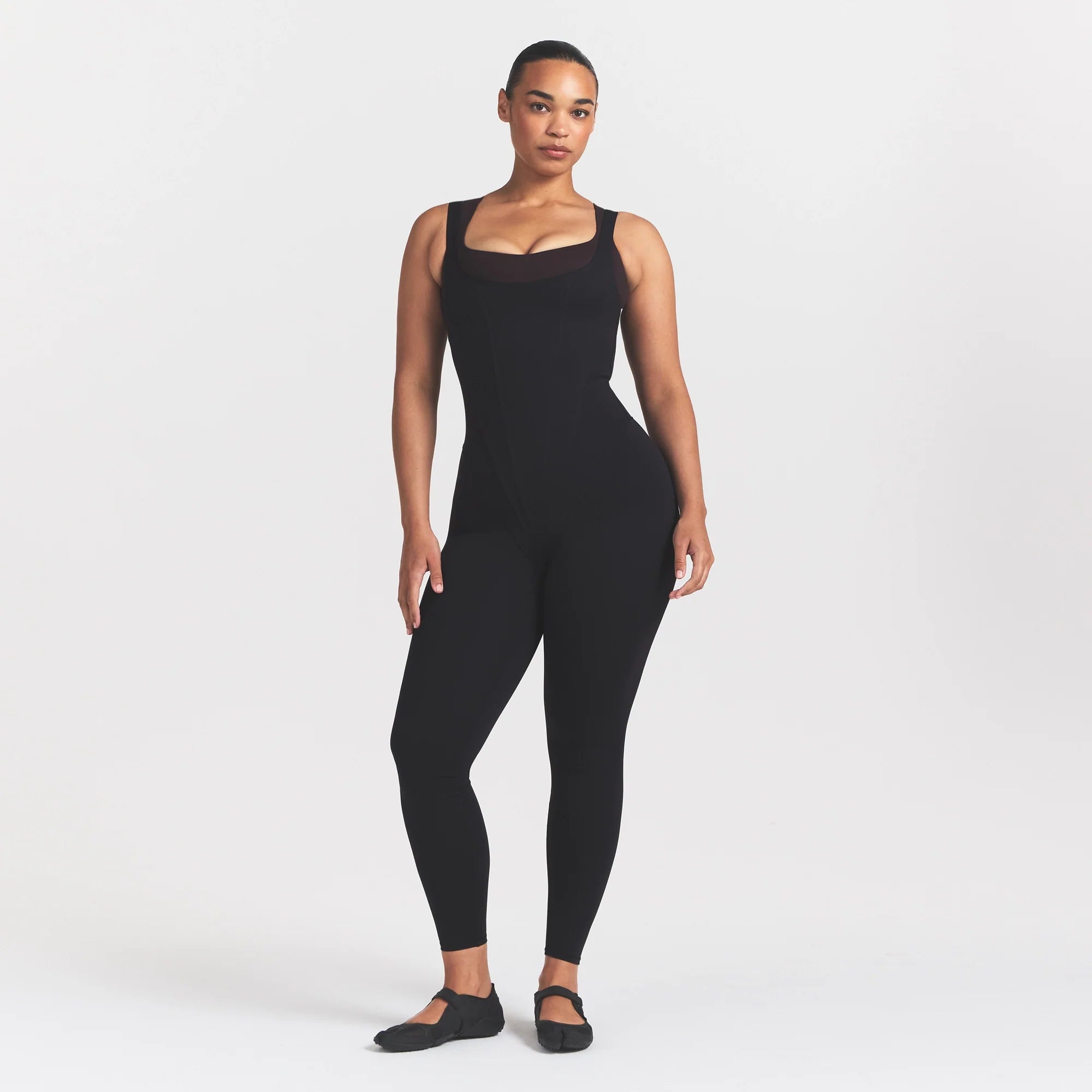 NikeSKIMS MATTE CORSET 29" ONE PIECE | OBSIDIAN ON A MODEL 