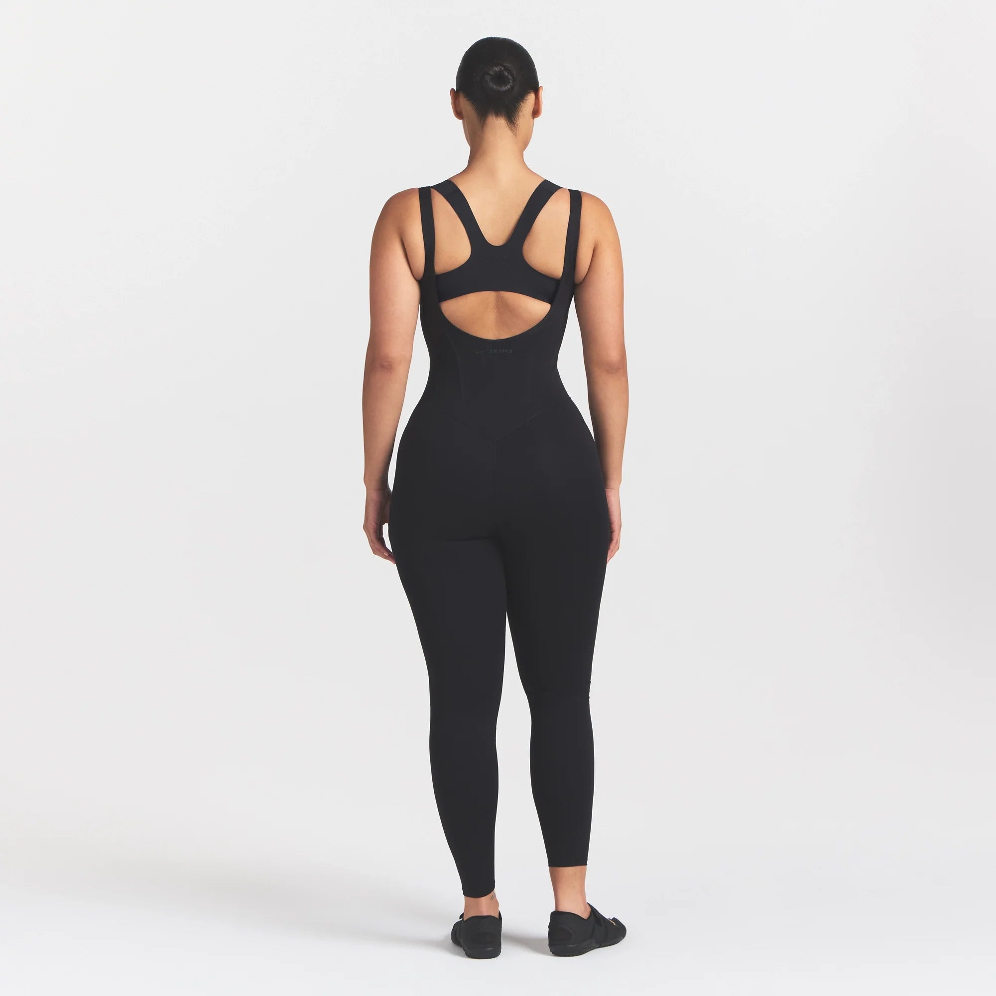 NikeSKIMS MATTE CORSET 29" ONE PIECE | OBSIDIAN ON A MODEL 