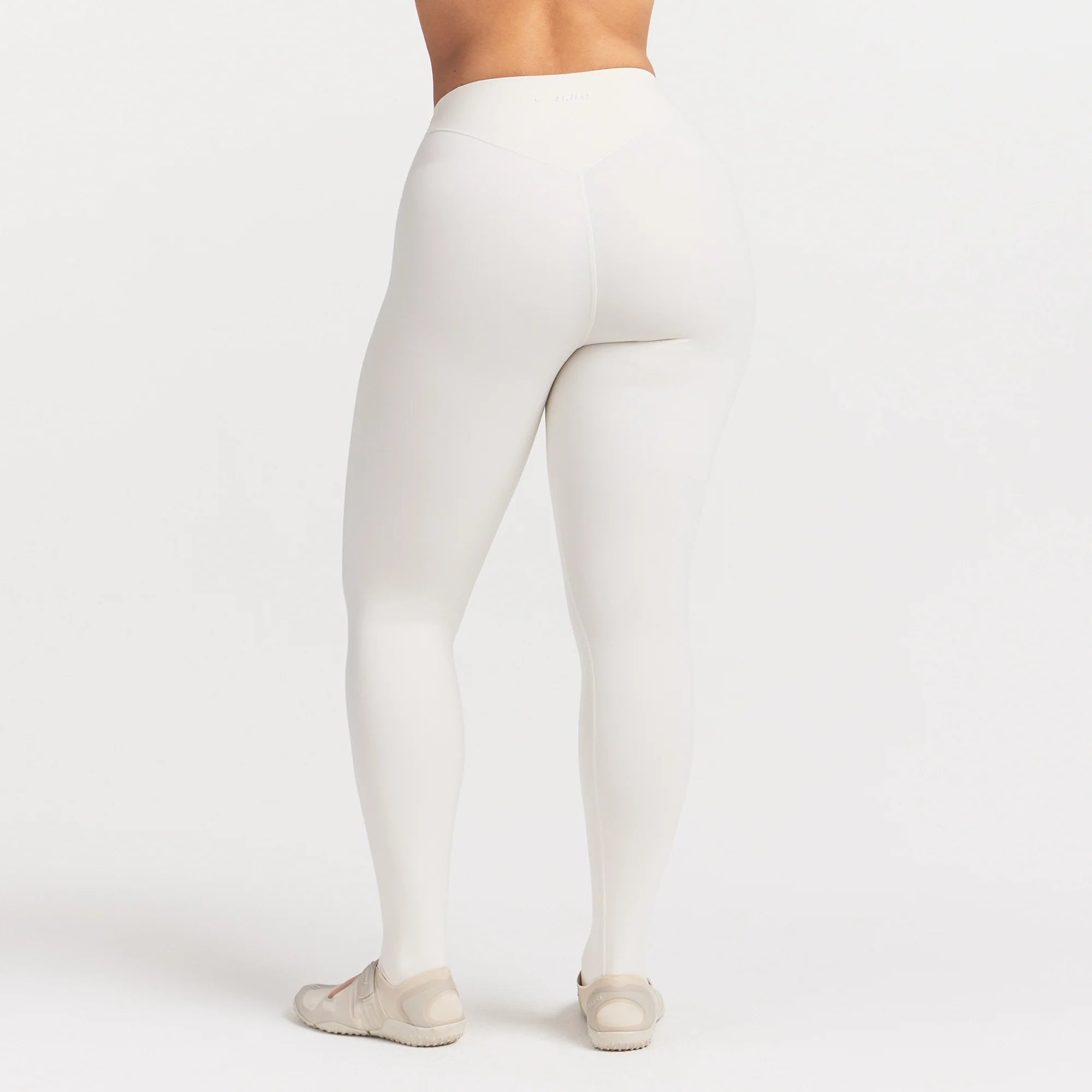 NikeSKIMS MATTE HIGH WAIST CORSET 26" LEGGING | IVORY ON A MODEL 
