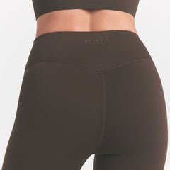 NikeSKIMS MATTE CROP 17" LEGGING | DARK SEPIA ON A MODEL FRONT VIEW @ | FOCUS: 0.0, 1.0, 0.9