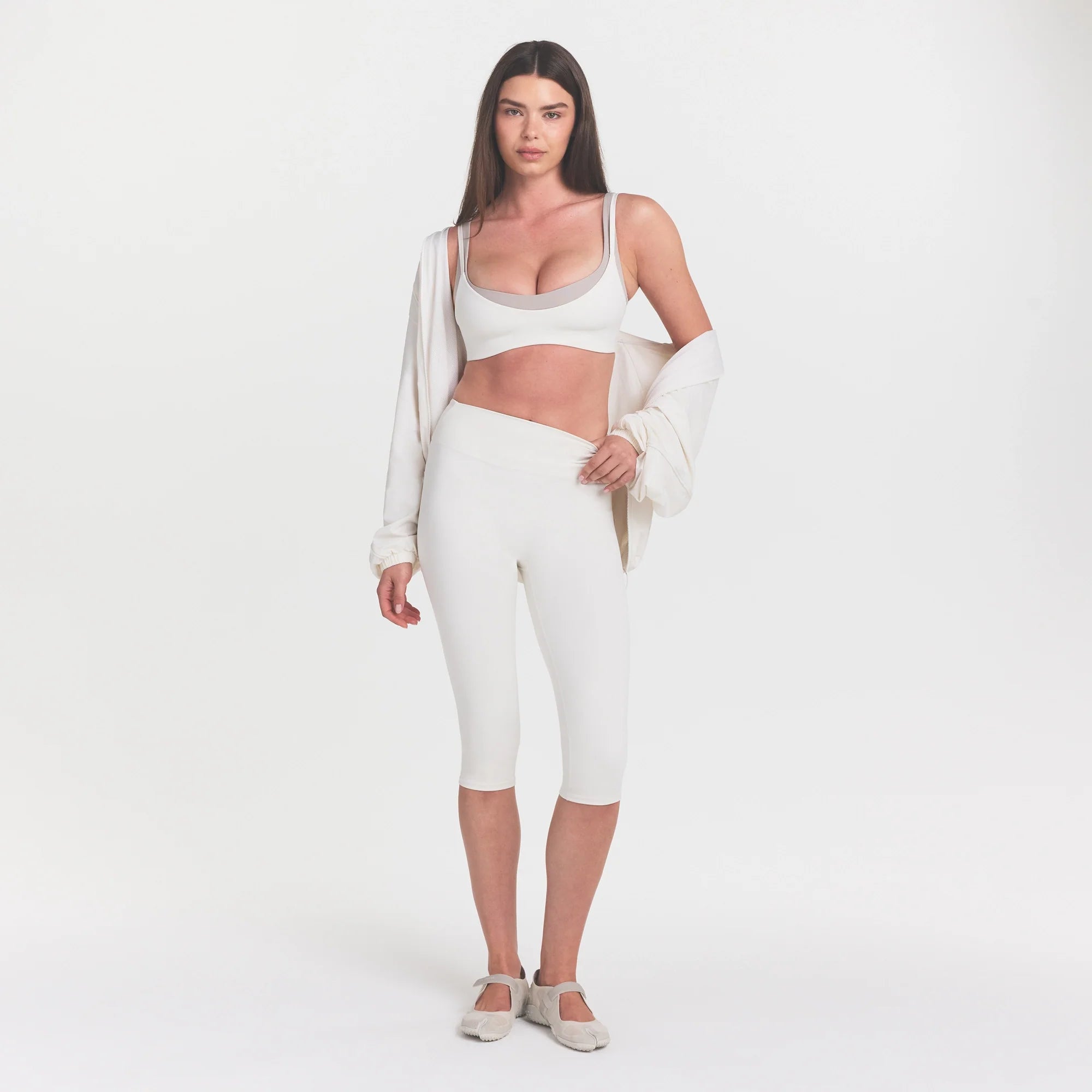 NikeSKIMS MATTE CROP 17" LEGGING | IVORY ON A MODEL 