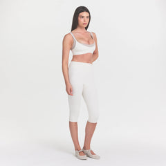 NikeSKIMS MATTE CROP 17" LEGGING | IVORY ON A MODEL 