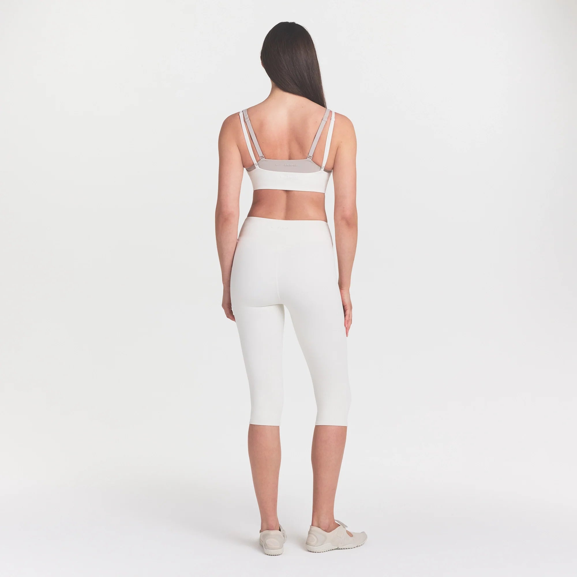 NikeSKIMS MATTE CROP 17" LEGGING | IVORY ON A MODEL 