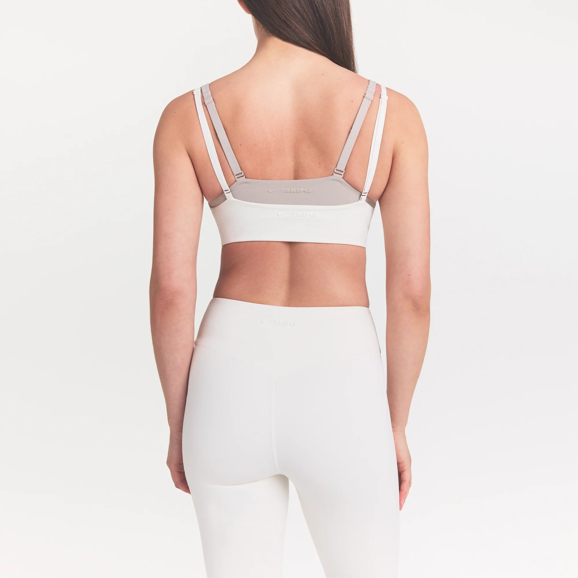 NikeSKIMS MATTE CROP 17" LEGGING | IVORY ON A MODEL 