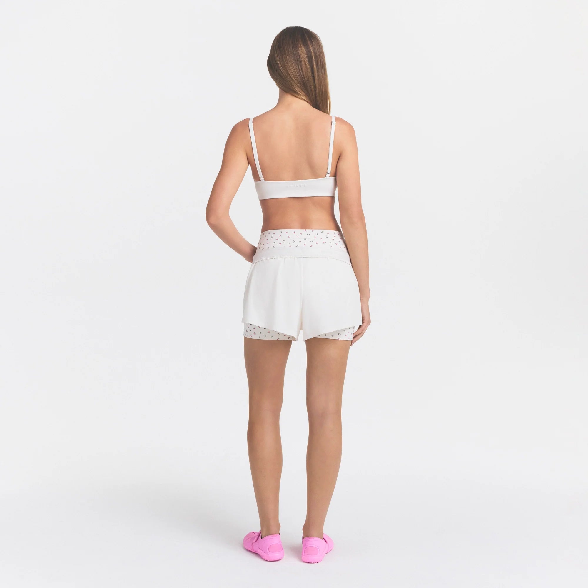 NikeSKIMS STRETCH NYLON RUNNER SHORT | IVORY ON A MODEL 