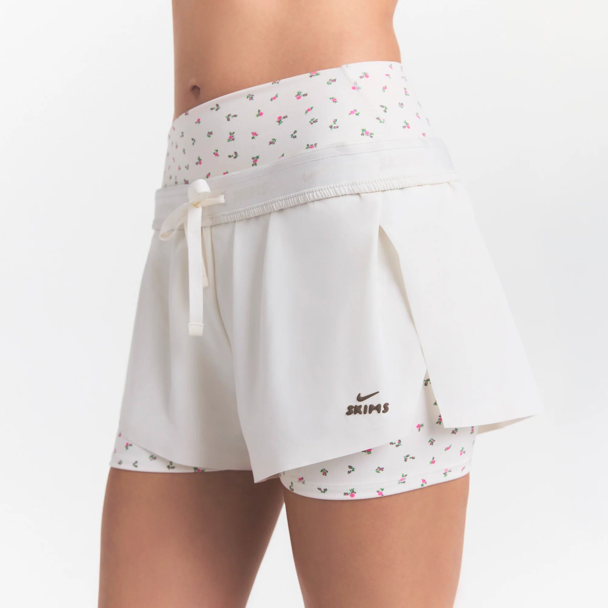 NikeSKIMS STRETCH NYLON RUNNER SHORT | IVORY ON A MODEL 