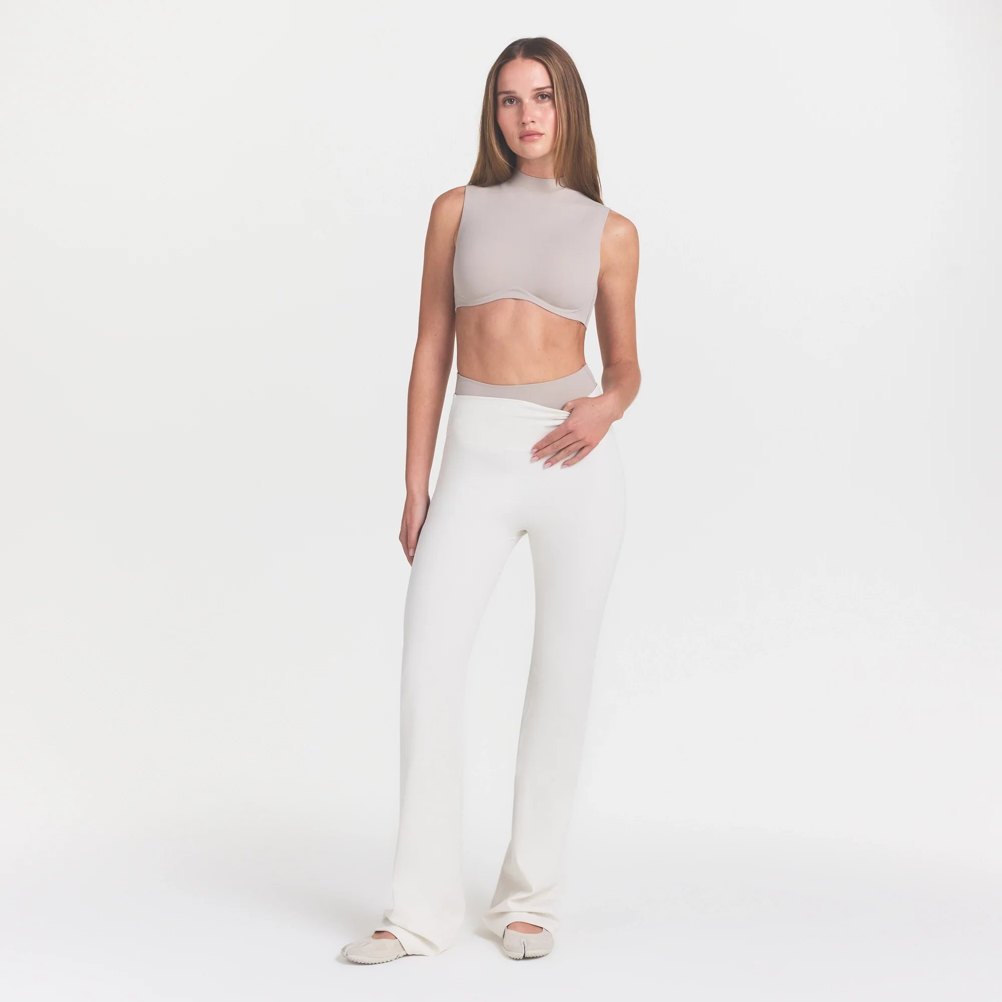 NikeSKIMS MATTE SLIM FLARE LEGGING | IVORY ON A MODEL 