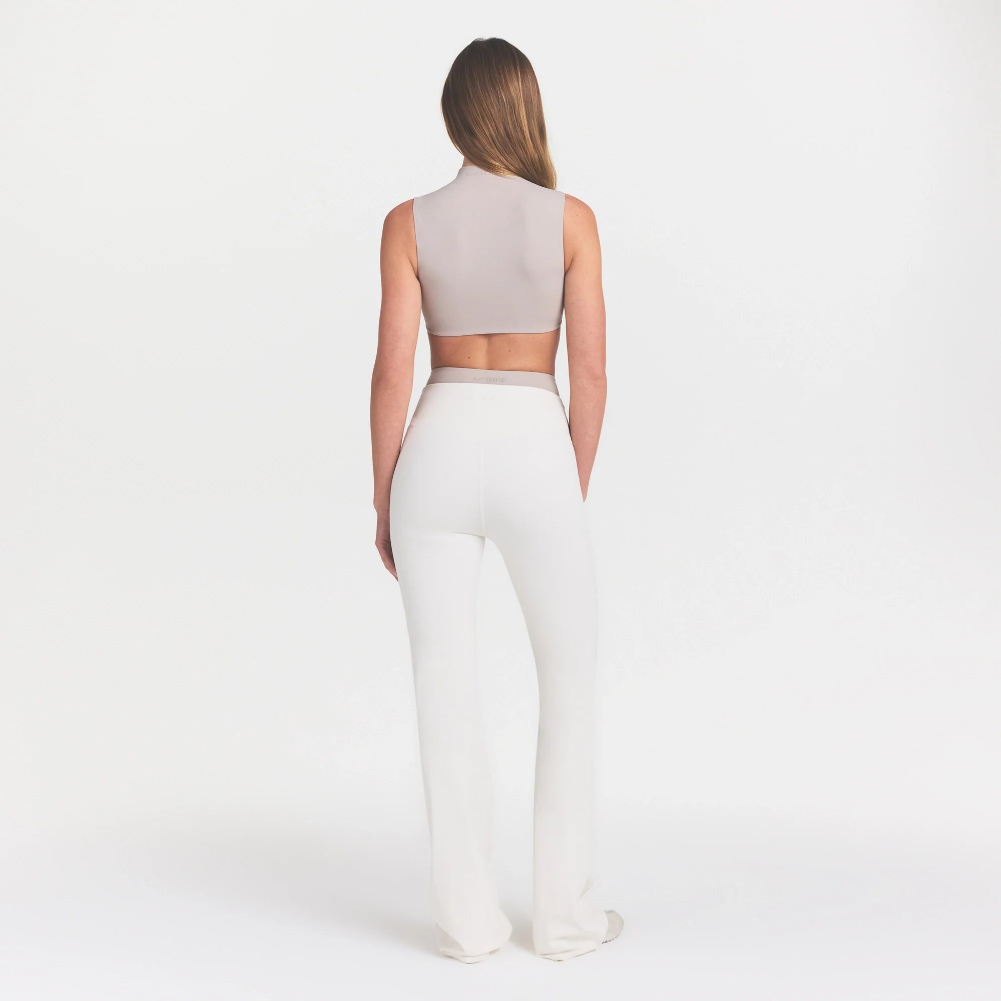 NikeSKIMS MATTE SLIM FLARE LEGGING | IVORY ON A MODEL 