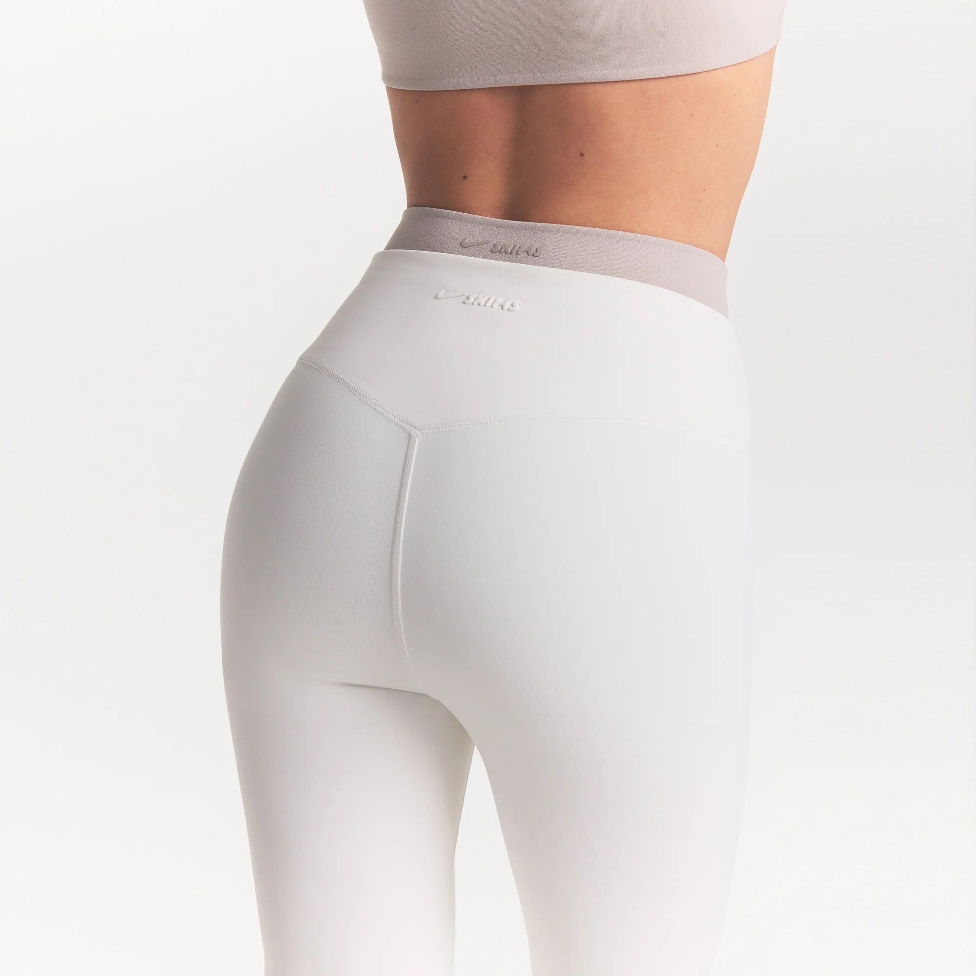 NikeSKIMS MATTE SLIM FLARE LEGGING | IVORY ON A MODEL 