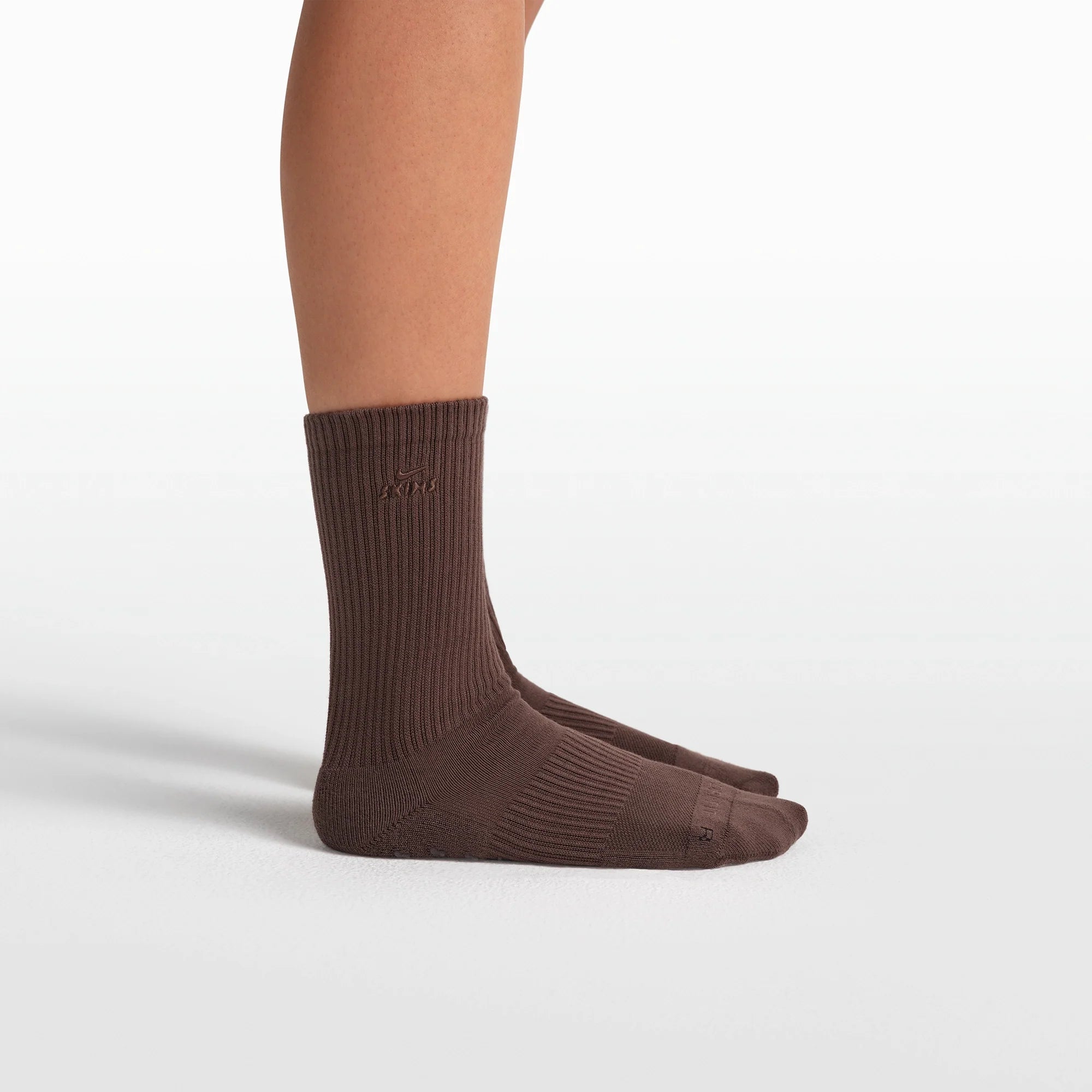 NikeSKIMS ACCESSORIES DRI-FIT PILATES GRIP CREW SOCK | DARK SEPIA FLAT ON A WHITE BACKGROUND