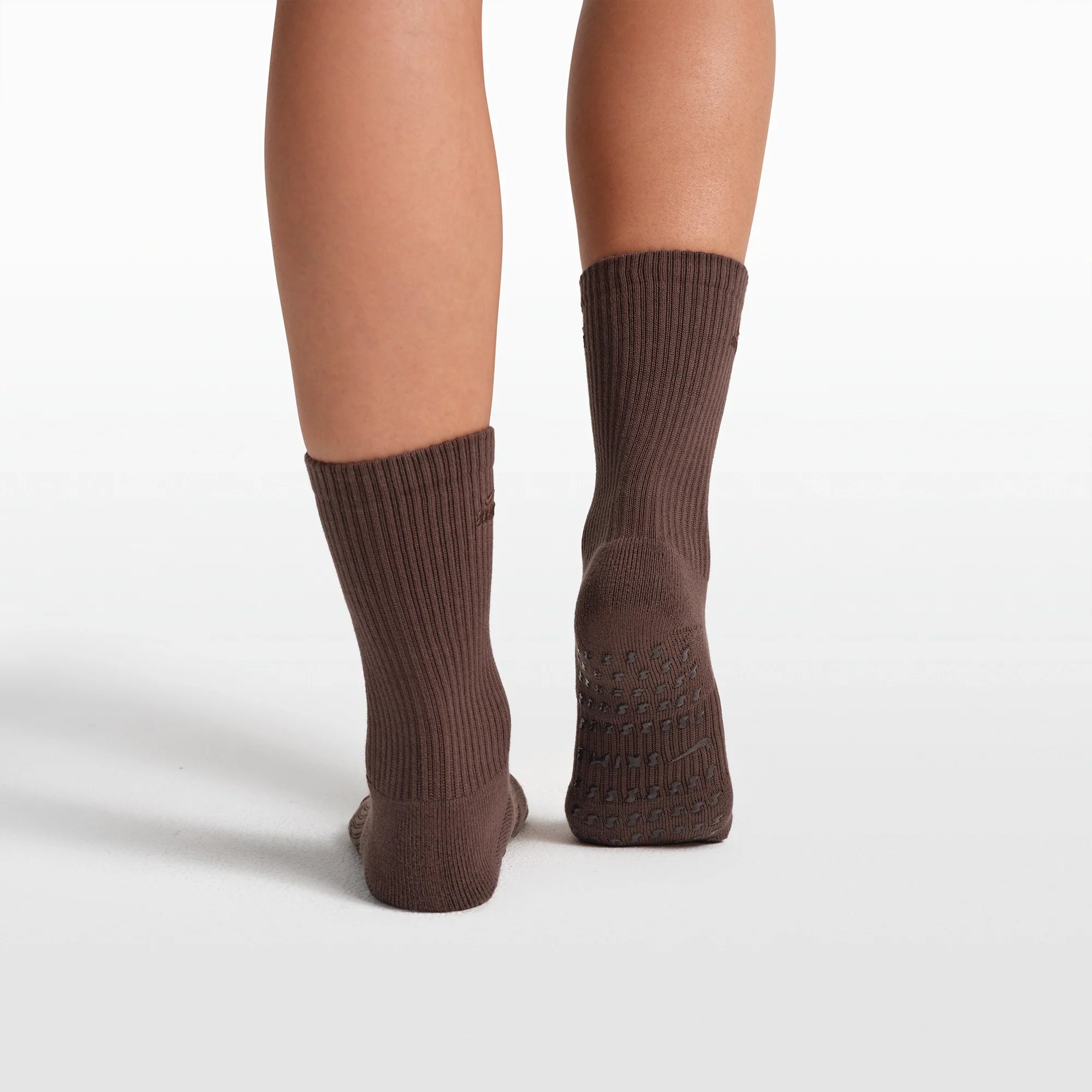 NikeSKIMS ACCESSORIES DRI-FIT PILATES GRIP CREW SOCK | DARK SEPIA FLAT ON A WHITE BACKGROUND