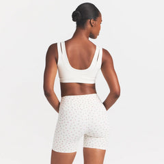NikeSKIMS MATTE 5" BIKER SHORT | DITSY FLORAL PRINT ON A MODEL 