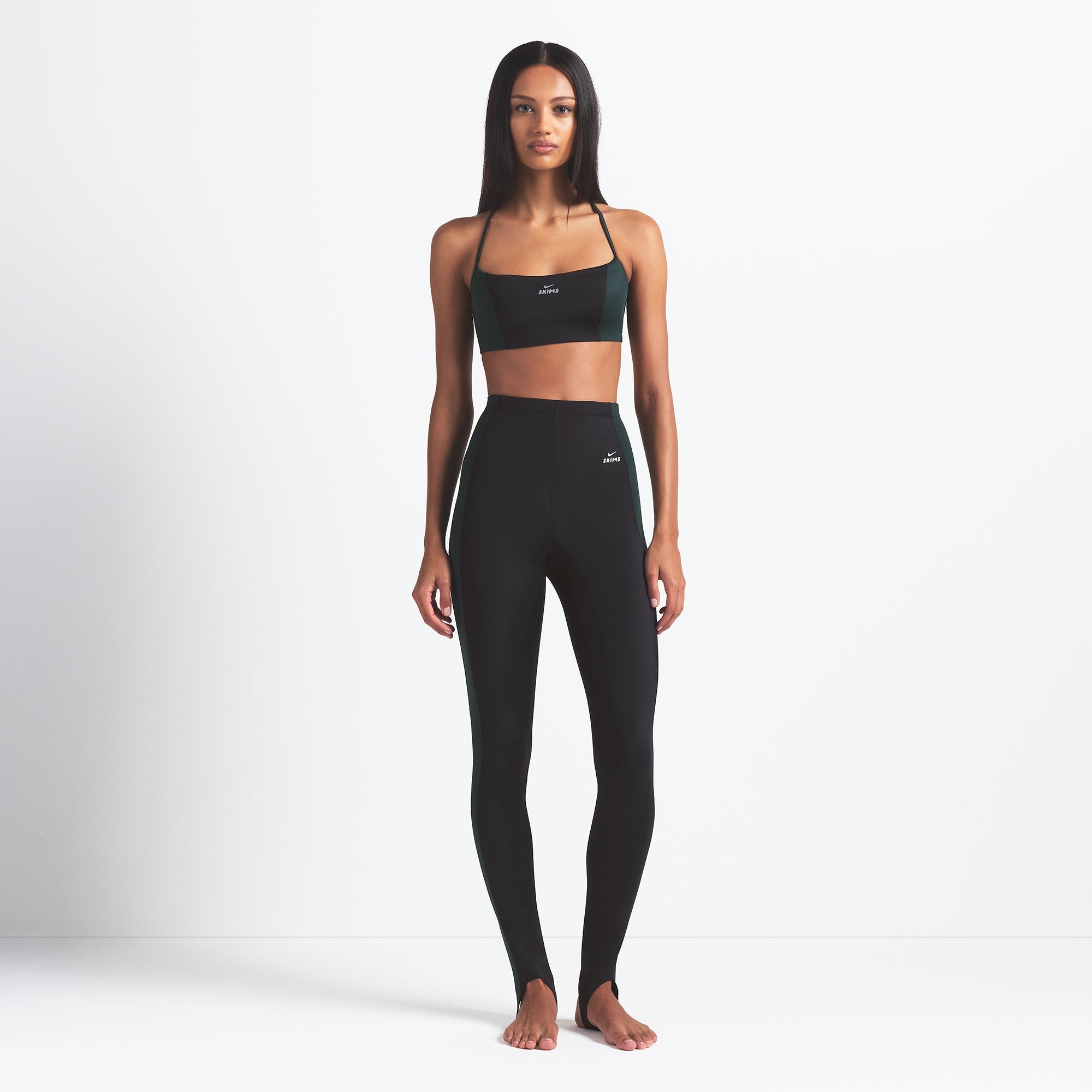 NikeSKIMS SHINE DRAWCORD STIRRUP 26" LEGGING | OBSIDIAN AND DARK TEAL ON A MODEL FRONT VIEW @ | FOCUS: 0.0, 1.0, 0.9