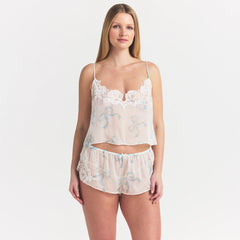 SKIMS ROMANCE CAMI AND SHORT SET | IVORY PEARL BOWS PRINT ON A MODEL SIDE VIEW @ | FOCUS: 0.0, 1.0, 0.9