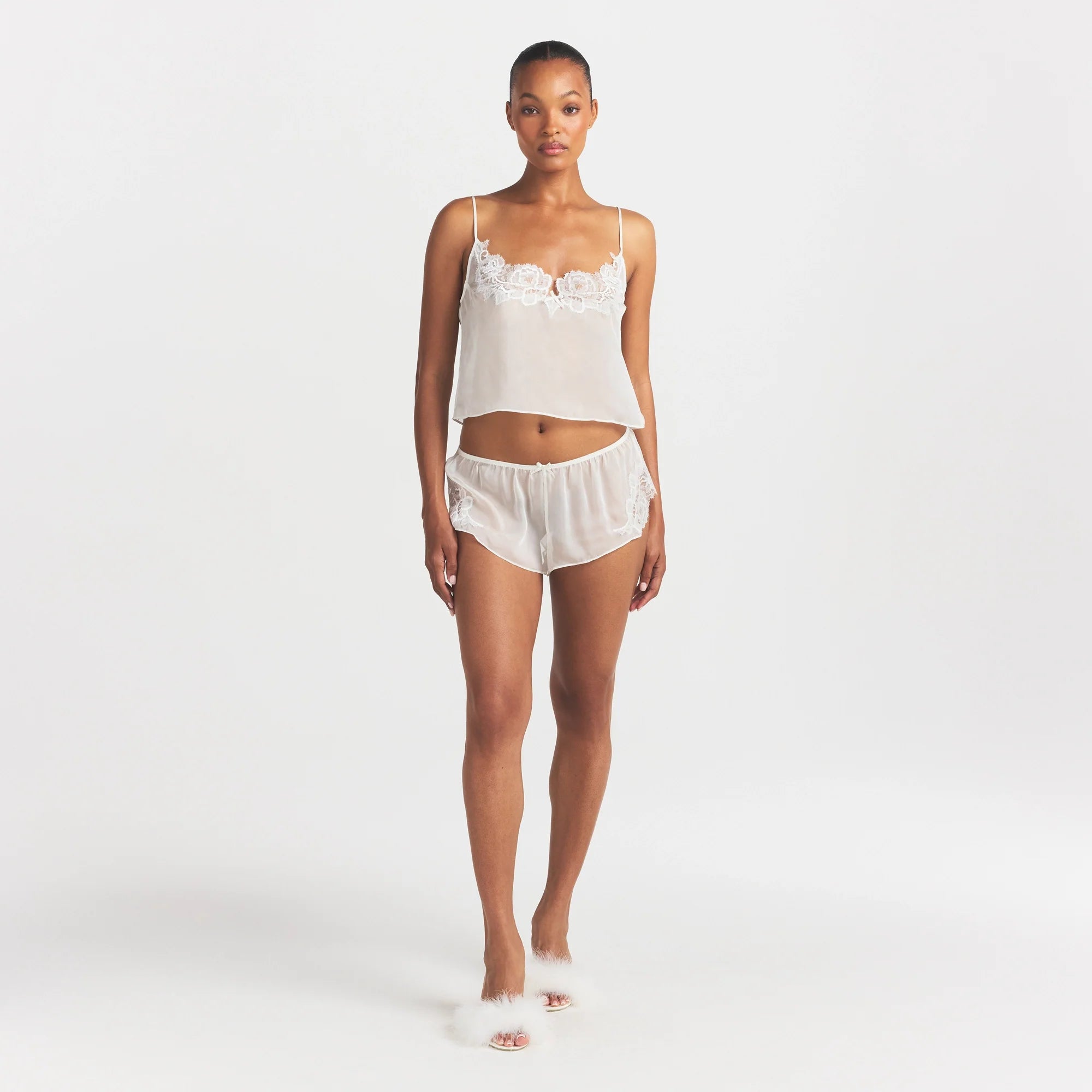SKIMS ROMANCE CAMI AND SHORT SET | IVORY ON A MODEL FRONT VIEW @ | FOCUS: 0.0, 1.0, 0.9