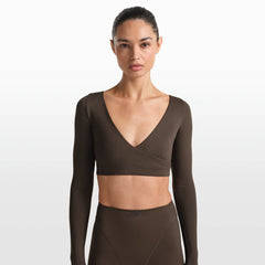 NikeSKIMS MATTE WRAP LONG SLEEVE CROPPED TOP | DARK SEPIA ON A MODEL FRONT VIEW @ | FOCUS: 0.0, 1.0, 0.9