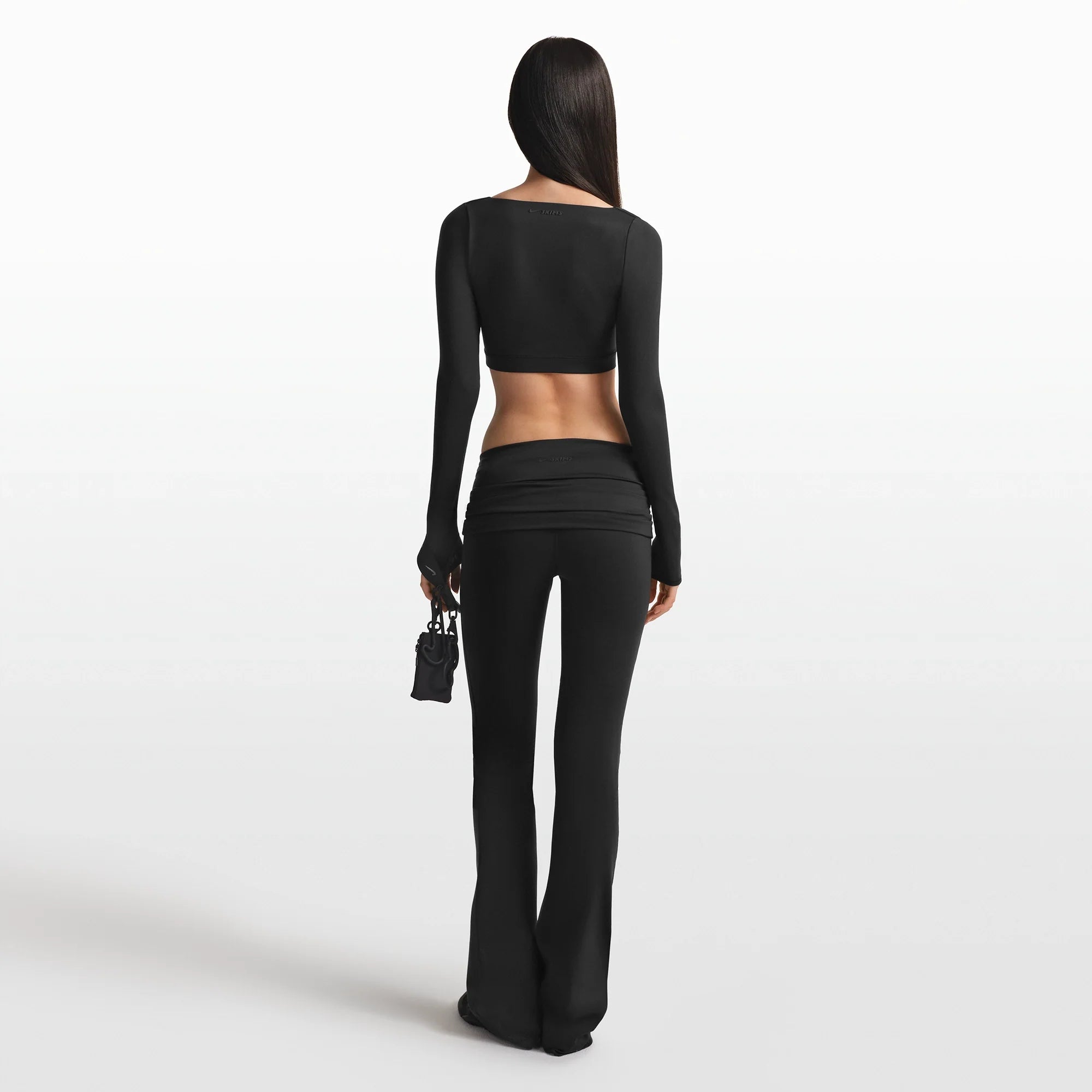 NikeSKIMS MATTE WRAP LONG SLEEVE CROPPED TOP | OBSIDIAN ON A MODEL FRONT VIEW @ | FOCUS: 0.0, 1.0, 0.9