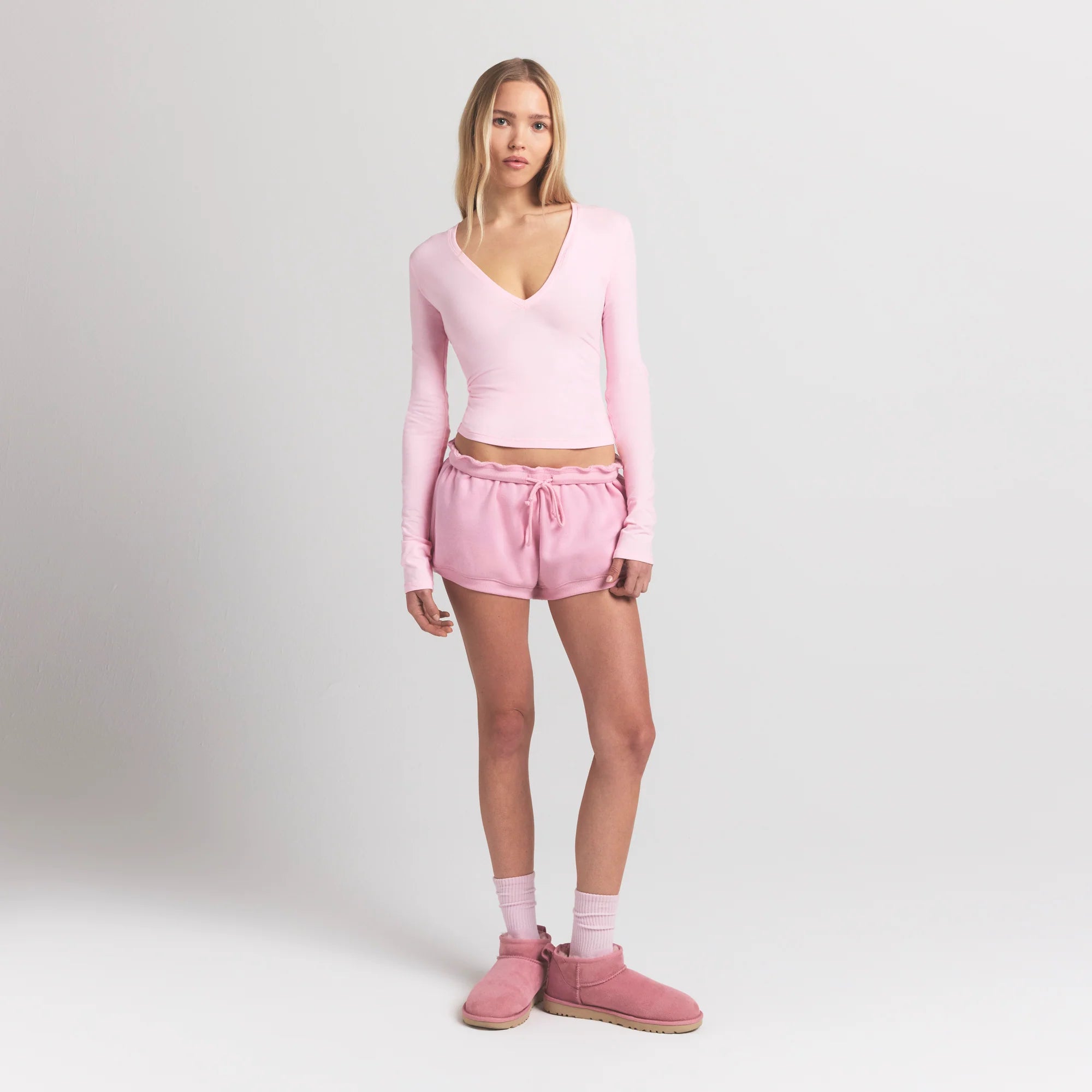 COTTON JERSEY LONG SLEEVE DEEP PLUNGE TOP | CHERRY BLOSSOM ON A MODEL FRONT VIEW S | FOCUS: 0.0, 1.0, 0.9