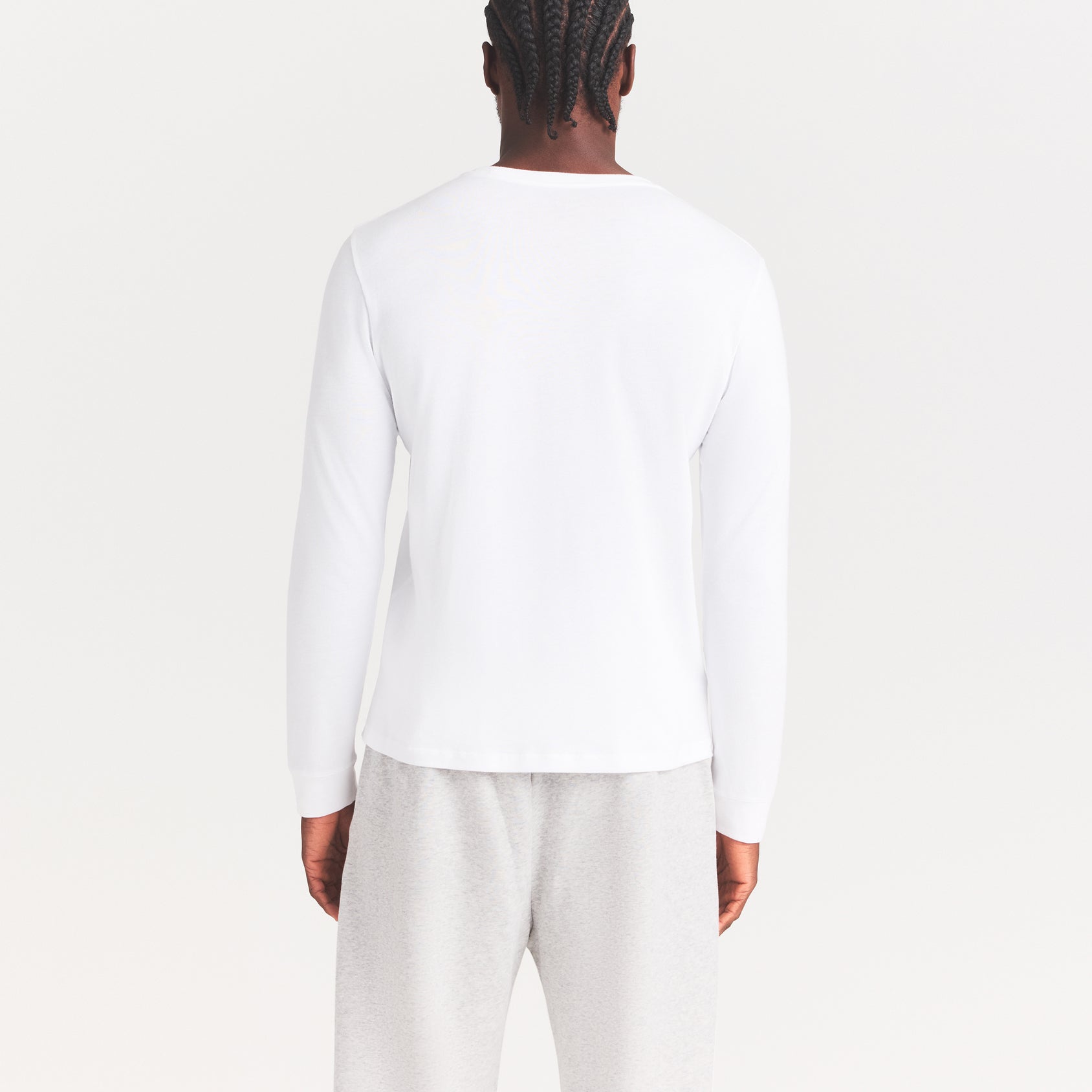 SKIMS COTTON MENS CLASSIC LONG SLEEVE T-SHIRT | CHALK ON A MODEL SIDE VIEW | FOCUS: 0.0, 1.0, 0.9