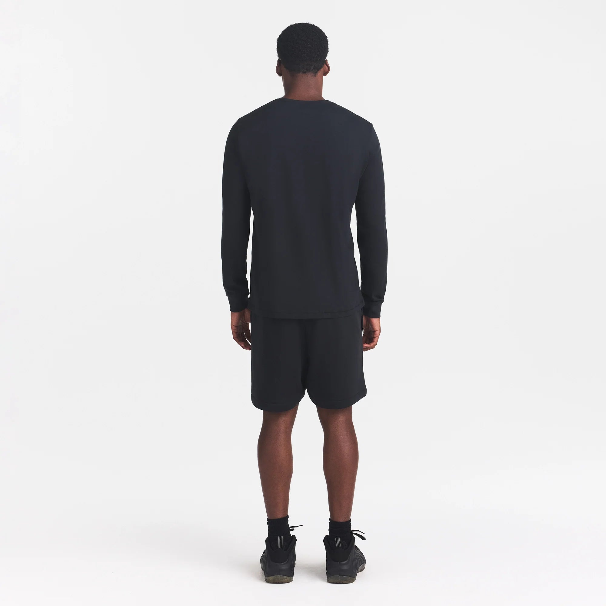 SKIMS COTTON MENS CLASSIC LONG SLEEVE T-SHIRT | ONYX ON A MODEL BACK VIEW
