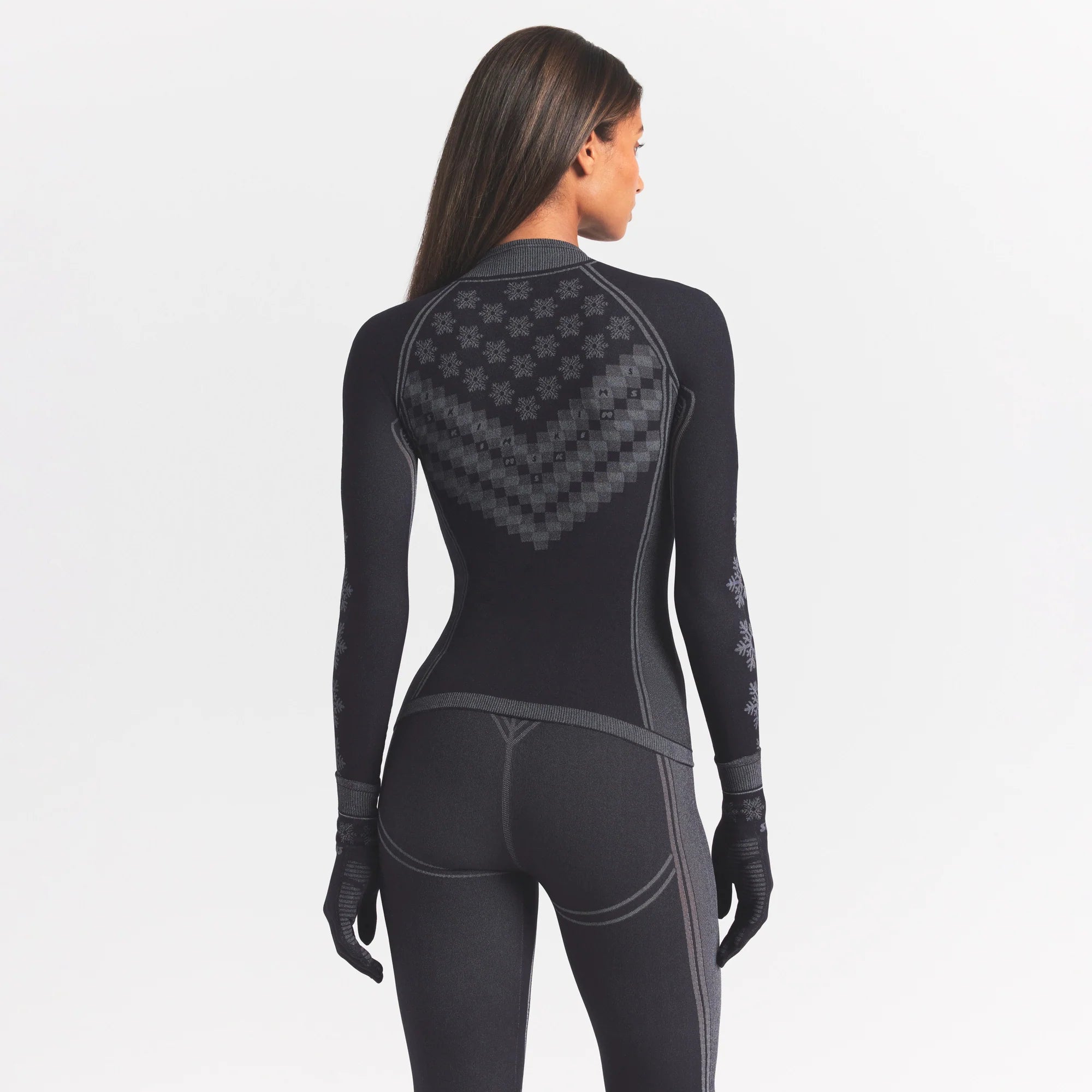 SKIMS FIRST LAYERS HALF ZIP LONG SLEEVE | OBSIDIAN WINTER FAIR ISLE ON A MODEL SIDE VIEW @ | FOCUS: 0.0, 1.0, 0.9