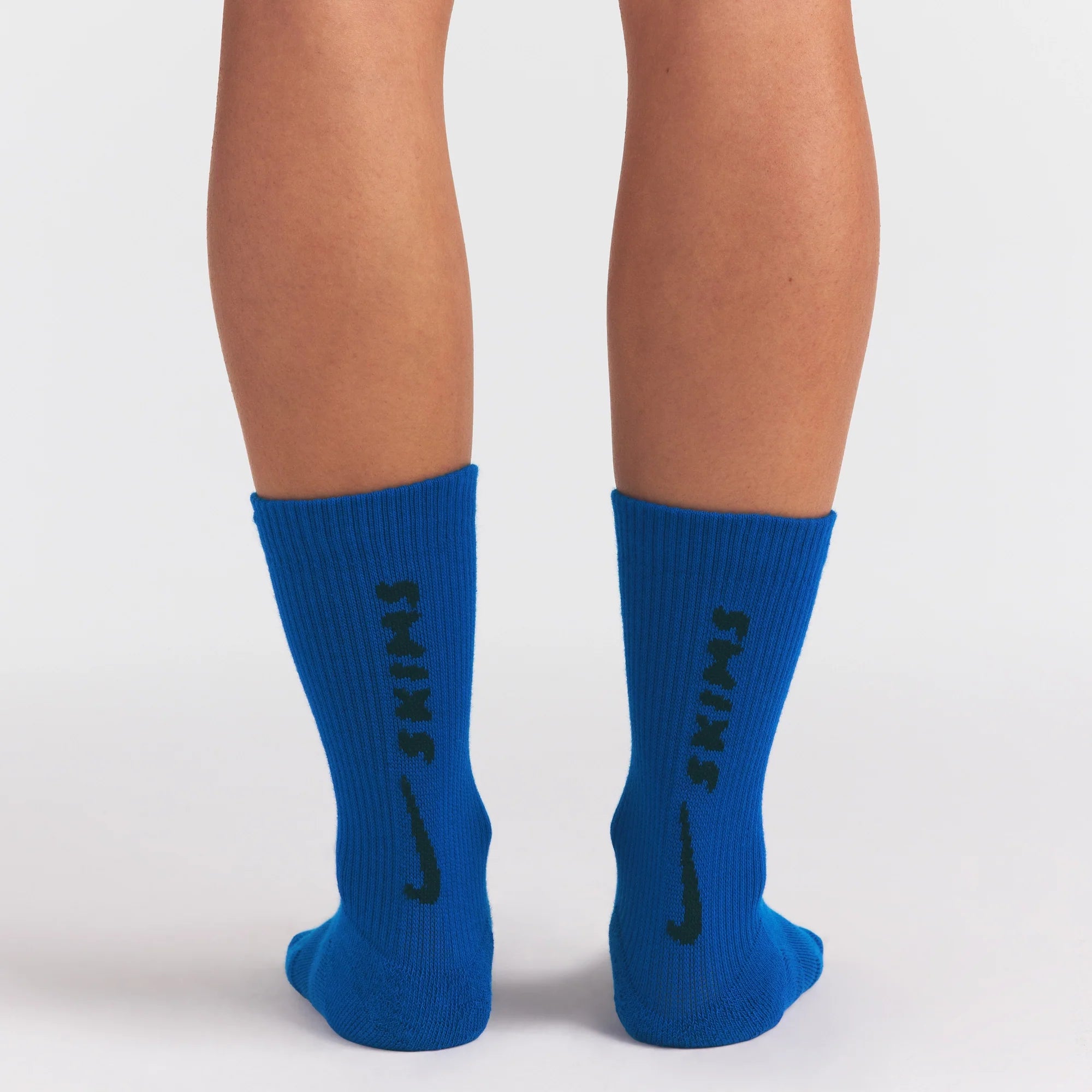 NikeSKIMS ACCESSORIES DRI-FIT™ CREW SOCK 3-PACK | COBALT MULTI ON A MODEL SIDE VIEW @ | FOCUS: 0.0, 1.0, 0.9