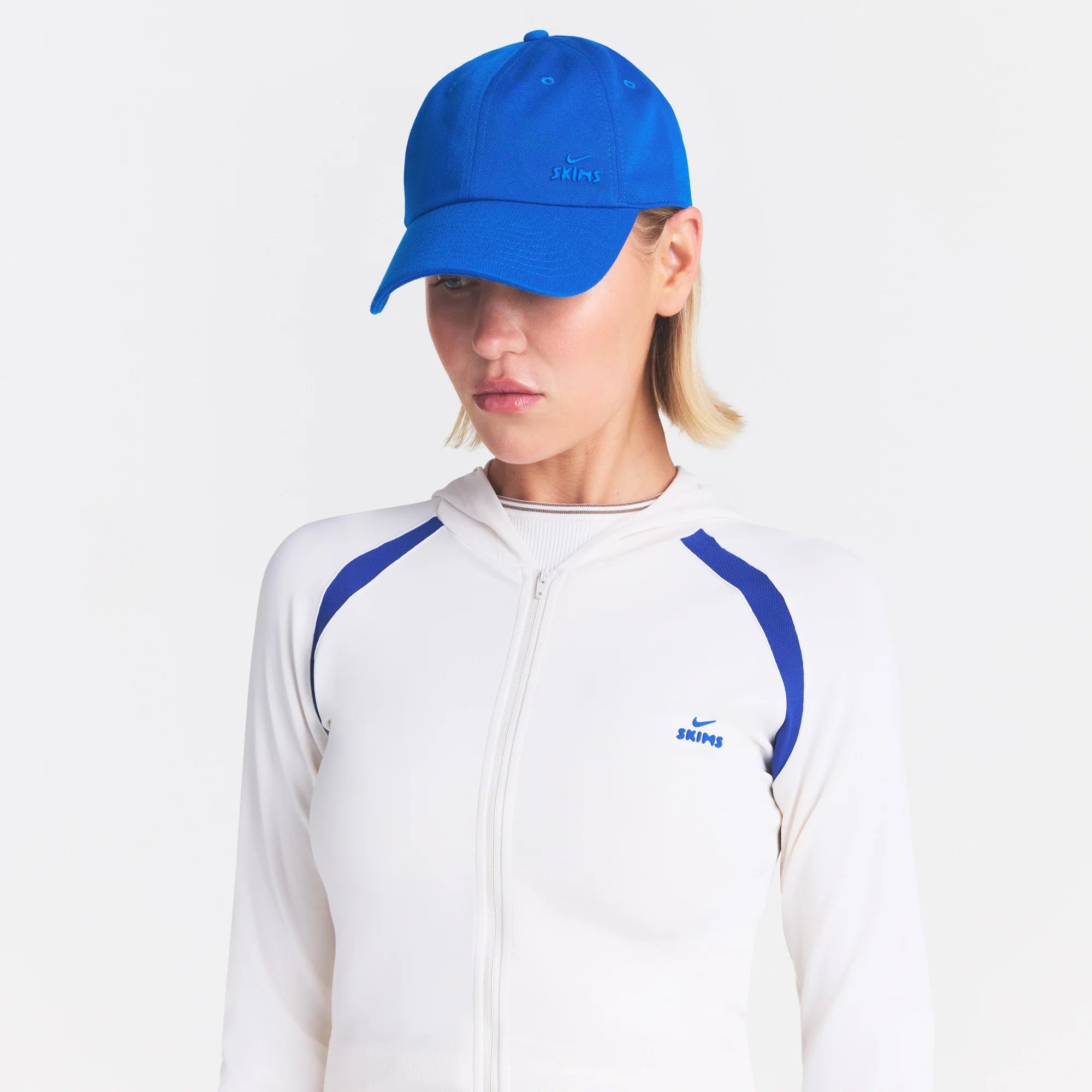 NikeSKIMS ACCESSORIES CLUB CAP | COBALT ON A MODEL SIDE VIEW @ | FOCUS: 0.0, 1.0, 0.9