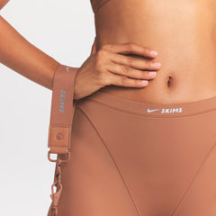 NikeSKIMS ACCESSORIES HARNESS WAISTPACK | CAROB BROWN ON MODEL FRONT VIEW @ | FOCUS: 0.0, 1.0, 0.9