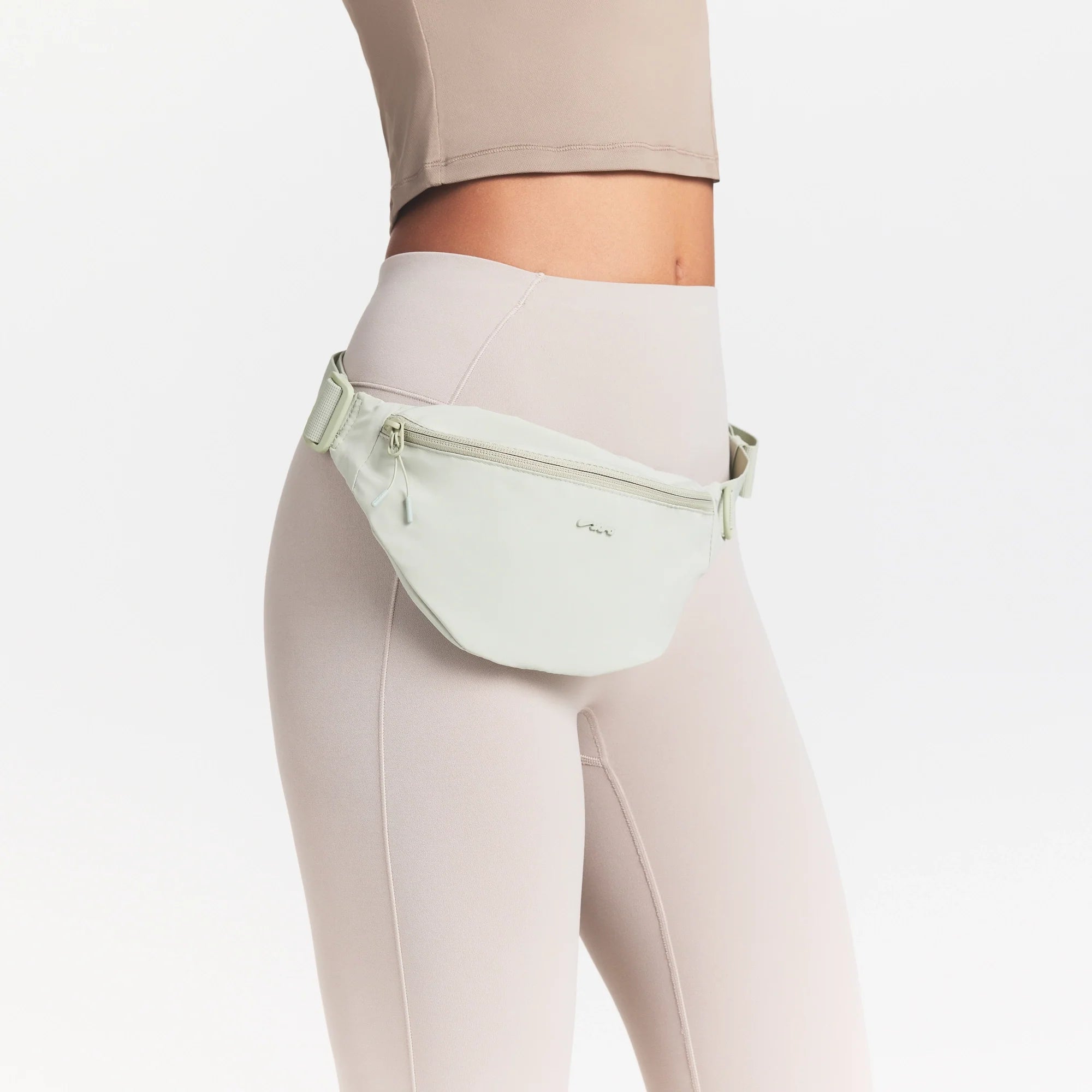 NikeSKIMS ACCESSORIES FANNY PACK | TALC ON A MODEL SIDE VIEW @ | FOCUS: 0.0, 1.0, 0.9