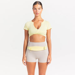 NikeSKIMS ACCESSORIES SLIM WAISTPACK | BICYCLE YELLOW ON A MODEL SIDE VIEW @ | FOCUS: 0.0, 1.0, 0.9