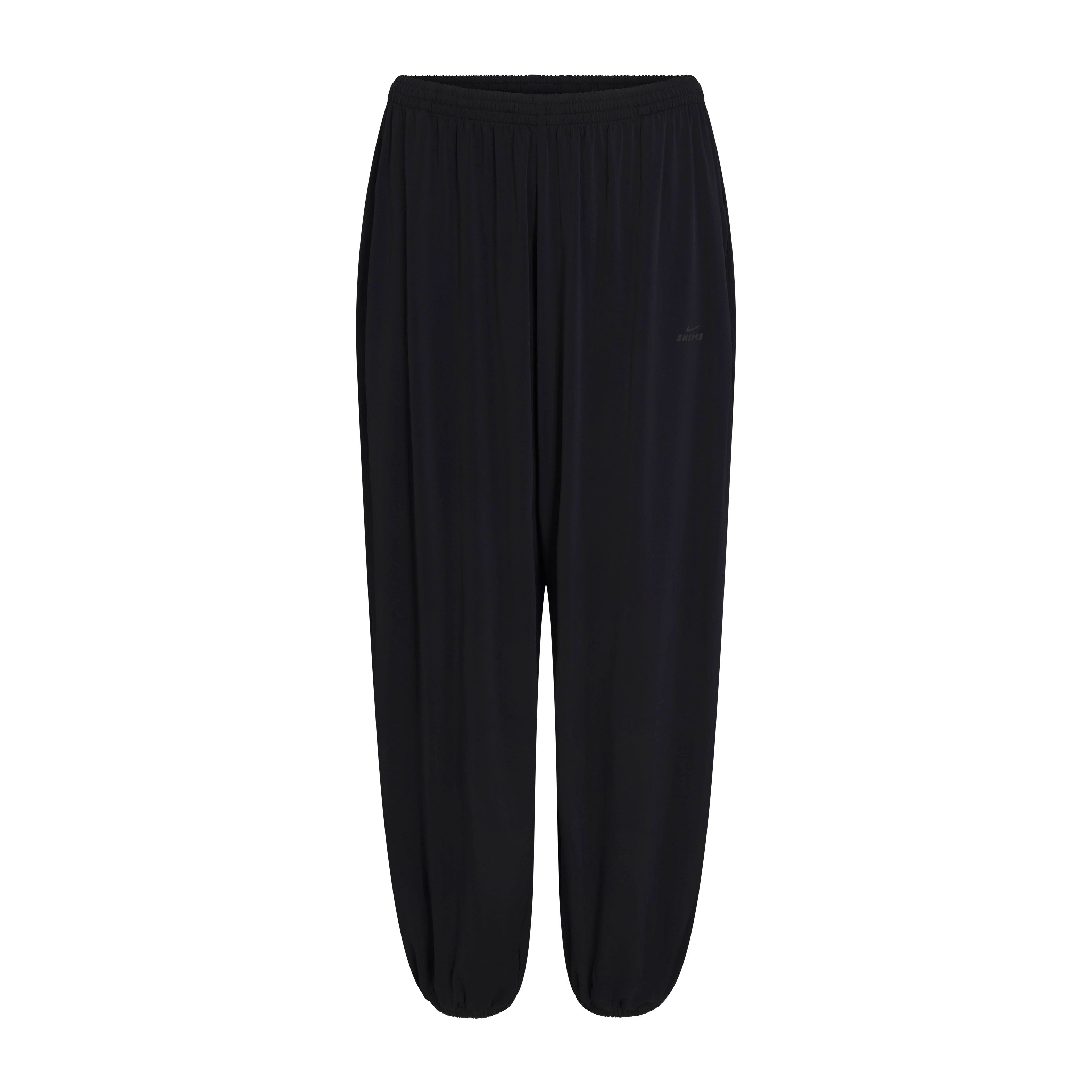 NikeSKIMS STRETCH KNIT HAREM PANT | NSKM OBSIDIAN/NSKM IGNEOUS FLAT ON A WHITE BACKGROUND | FLT