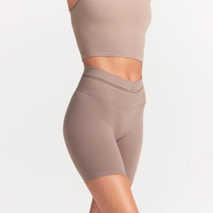 NikeSKIMS RIBBED SEAMLESS 5" BIKER SHORT | DRIFTWOOD ON A MODEL SIDE VIEW @ | FOCUS: 0.0, 1.0, 0.9